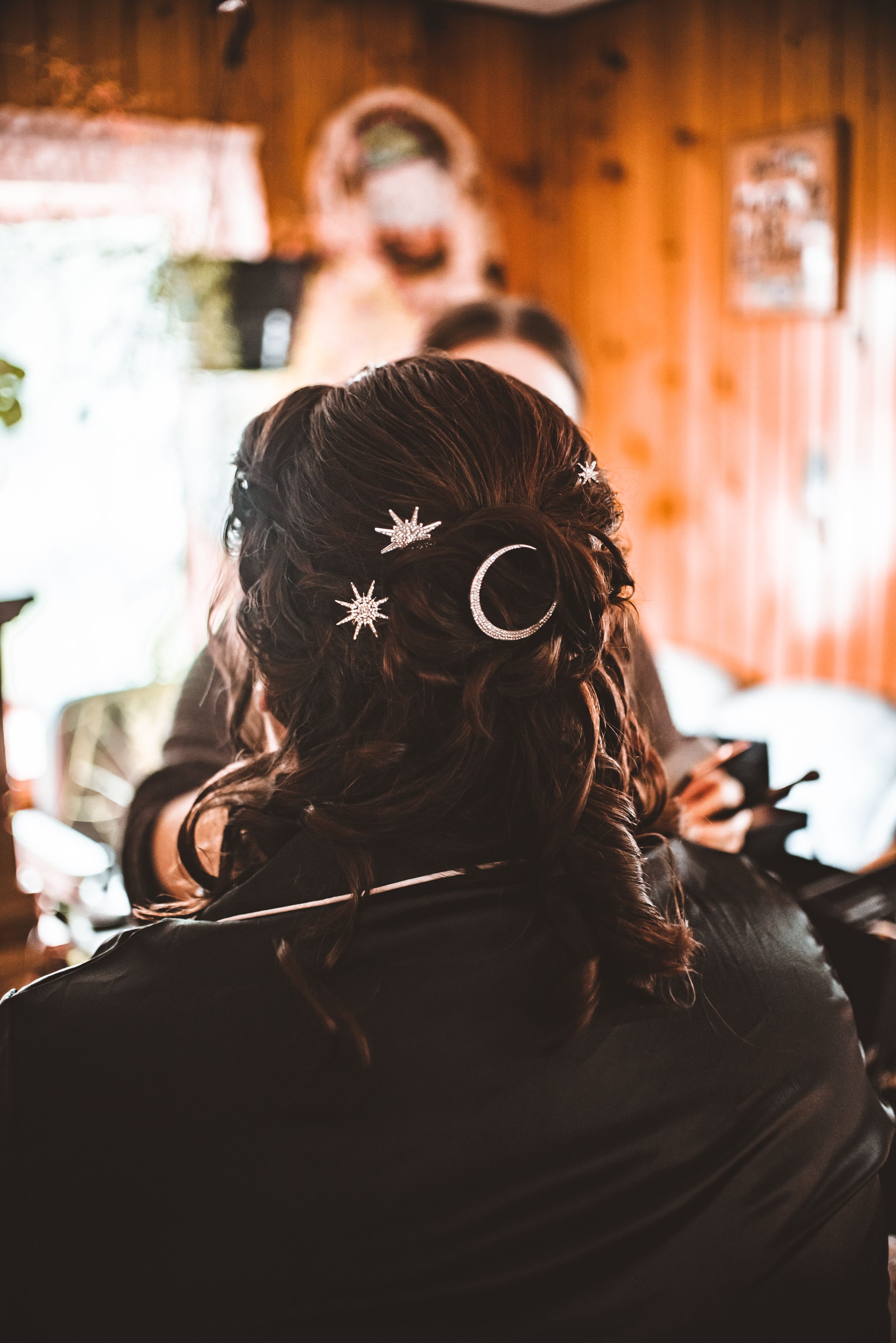 Wedding hair styling details featuring celestial moon and star hair accessories.