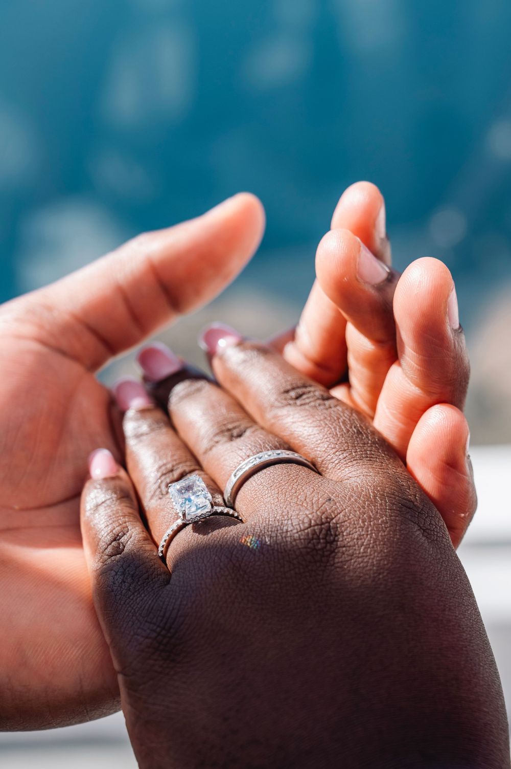 Close up of engagement ring being placed on hand during proposal.