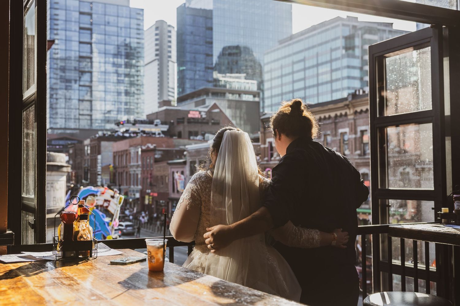 Silhouettes enjoying drinks at a high-rise bar overlooking a cityscape. Pittsburgh Weddings by Pittsburgh Photographers