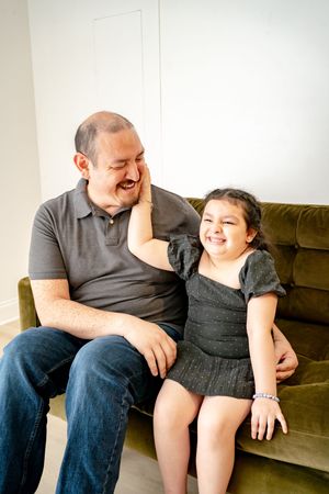 Candid family moments showing joyful interactions on a brown couch.