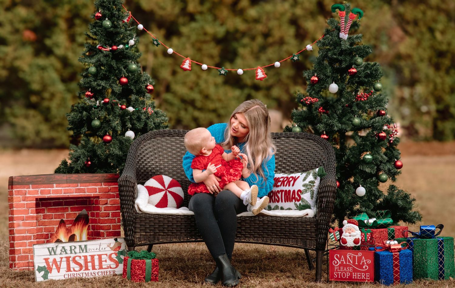 Holiday scene with decorated Christmas trees, presents and outdoor bench setting.