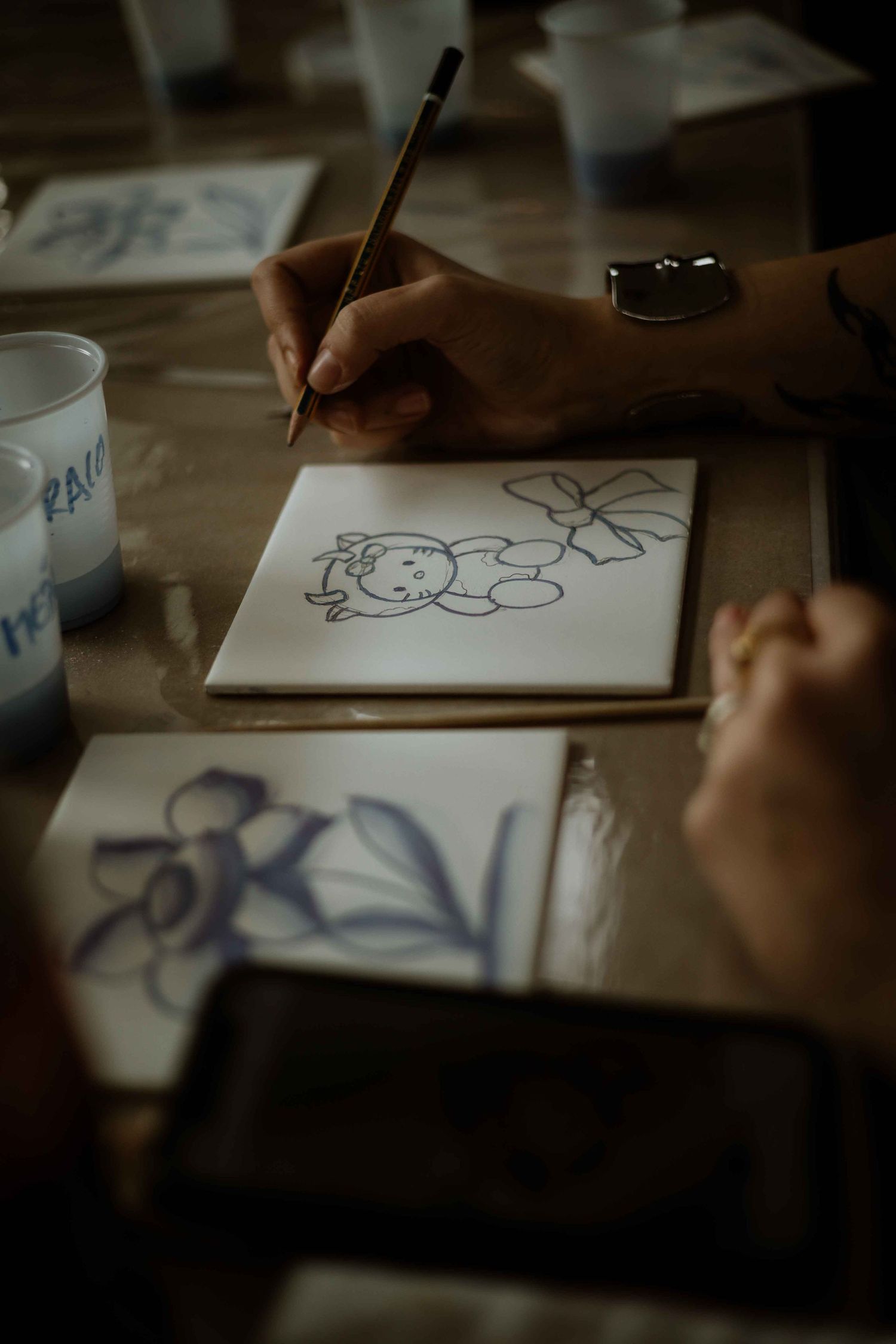 Close-up shot of hands drawing simple illustrations on paper.