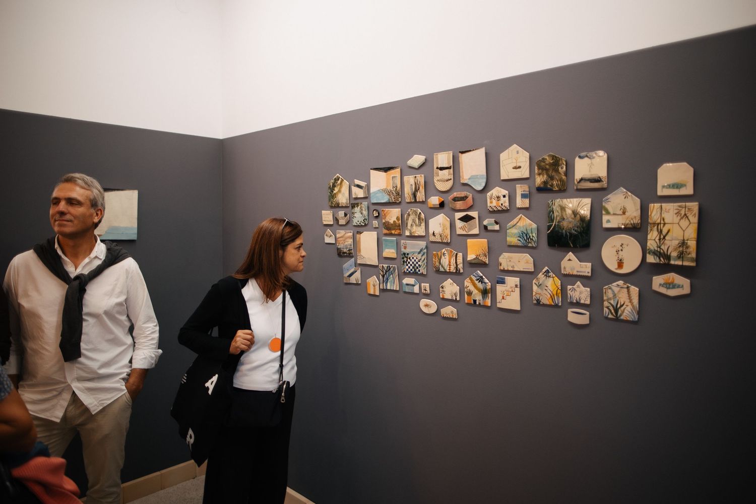 Gallery wall displaying a collection of framed photographs in a horizontal arrangement.