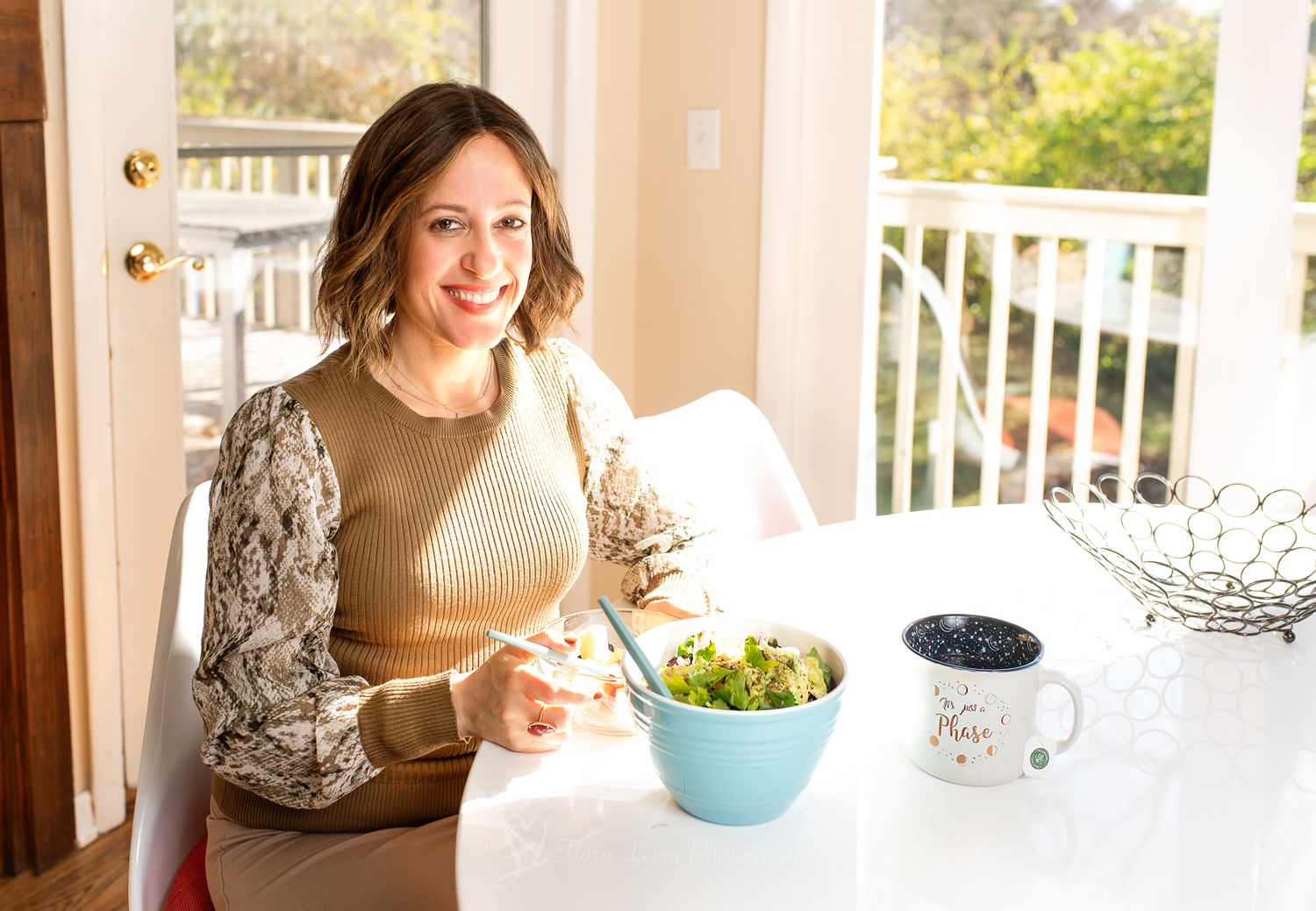 Woman having lunch in a sunny breakfast room.