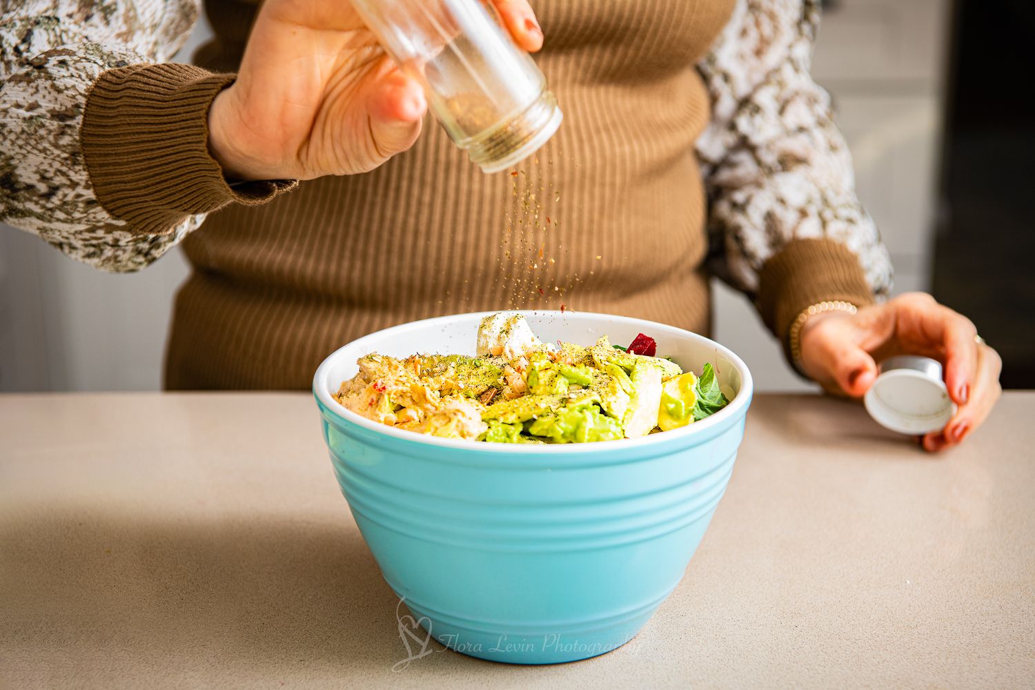 A woman preparing a salad.