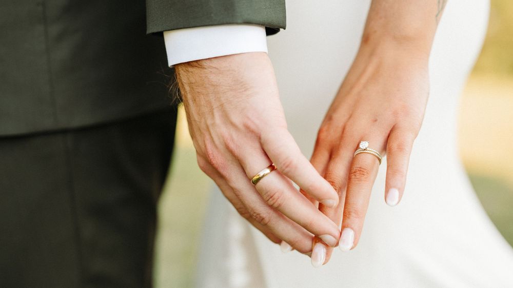 Three women's hands intertwined with engagement rings showcasing a variety of diamond styles and settings.