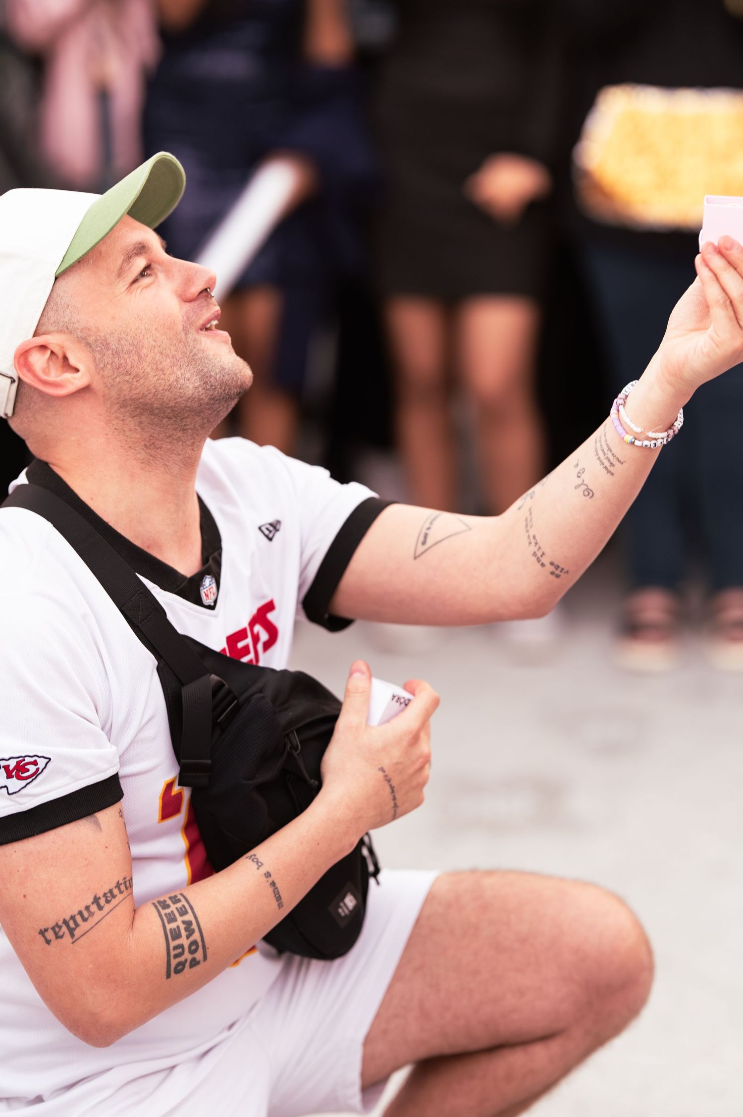Sports fan in white jersey gesturing enthusiastically during game celebration.