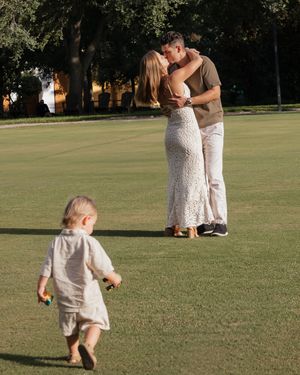 Family enjoying a sunny day on a sprawling green lawn.