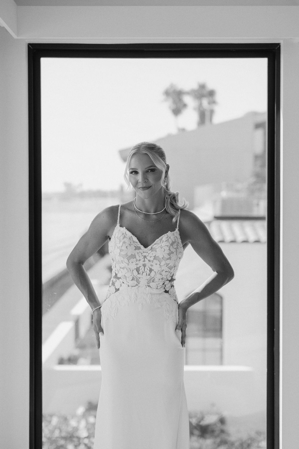 Black and white photo series showing a wedding dress with delicate lace detail and spaghetti straps in natural light.