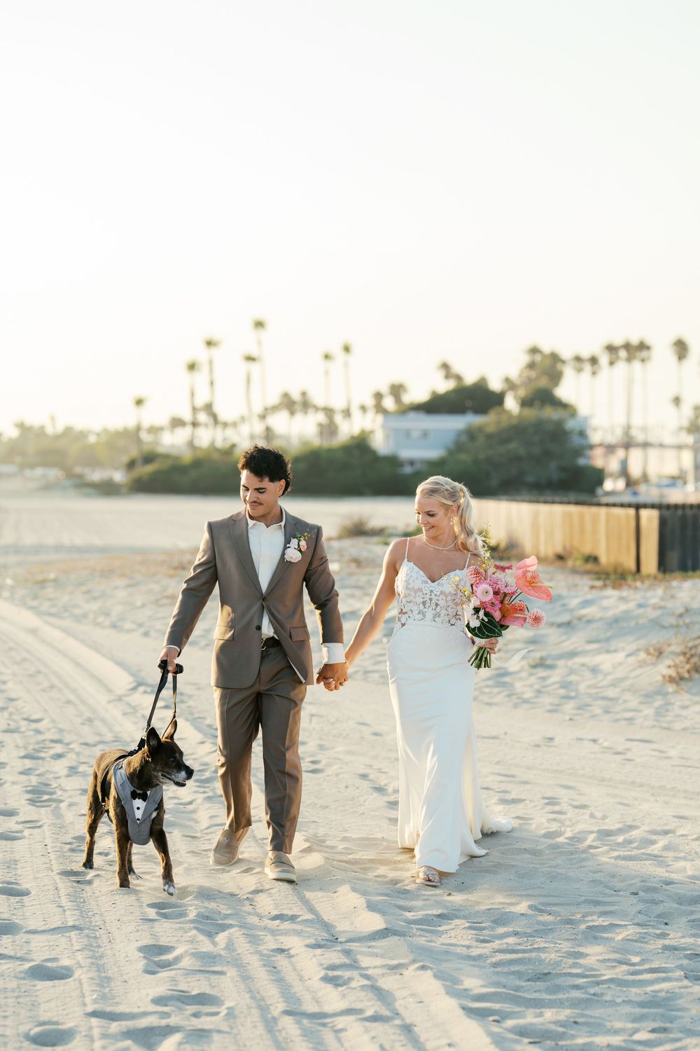 A romantic beach photoshoot sequence showing a couple walking and playing in the white sand at sunset.
