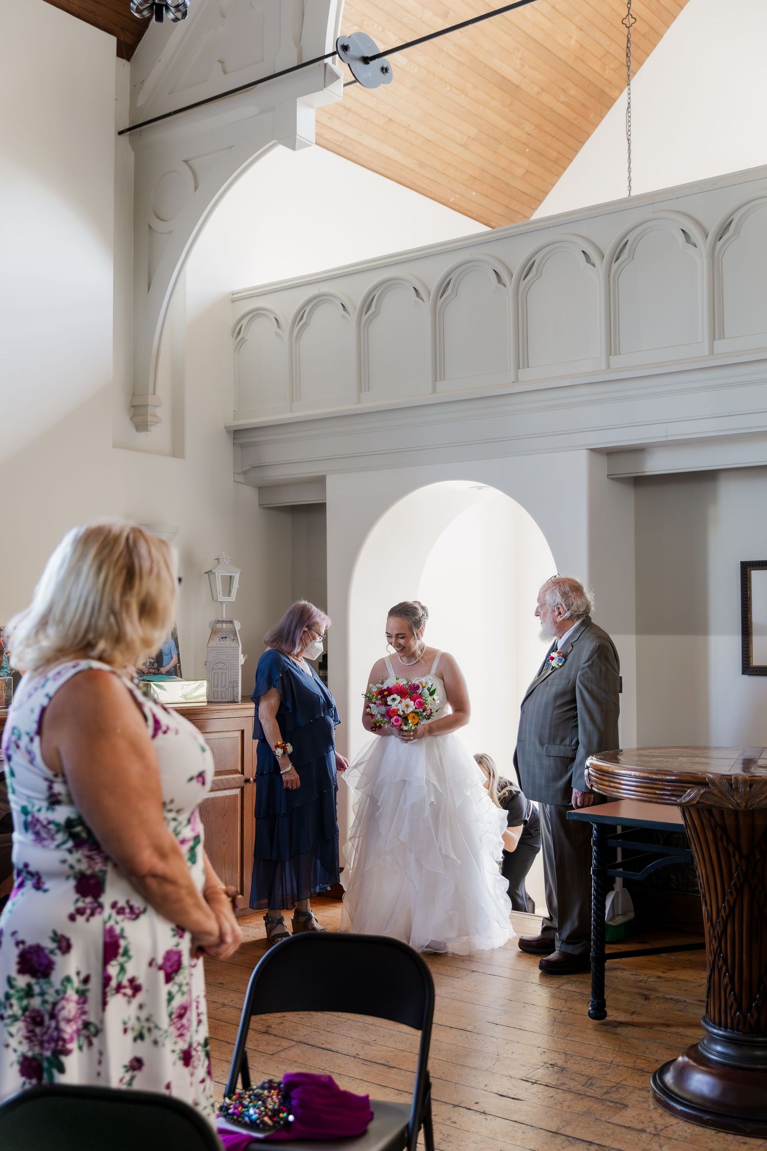Bride gets ready to walk down the aisle in the back corner of the chapel room at Hauser Hall in Kitchener, Ontario.