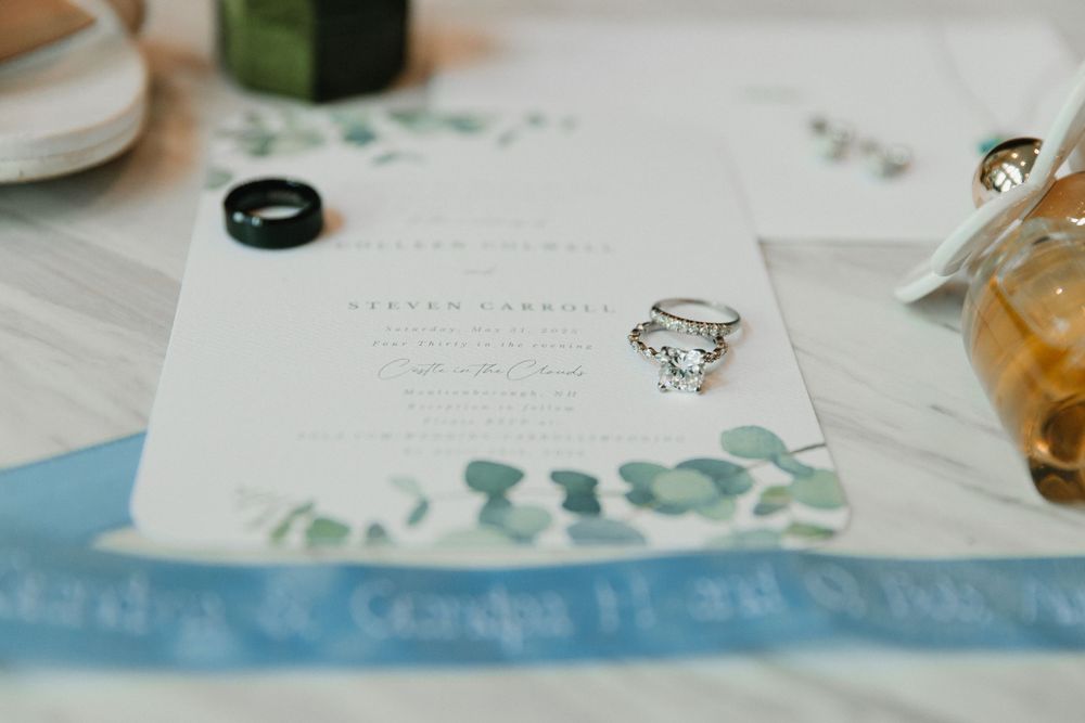 Wedding invitation suite featuring delicate watercolor designs in blue and green tones.