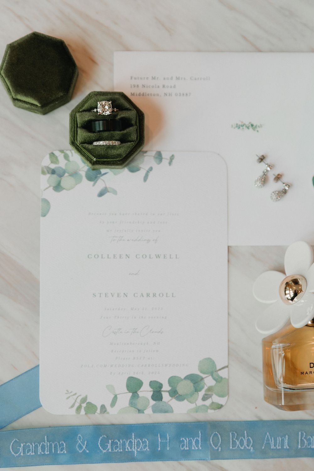 Classic white wedding invitations with blue and green watercolor accents.