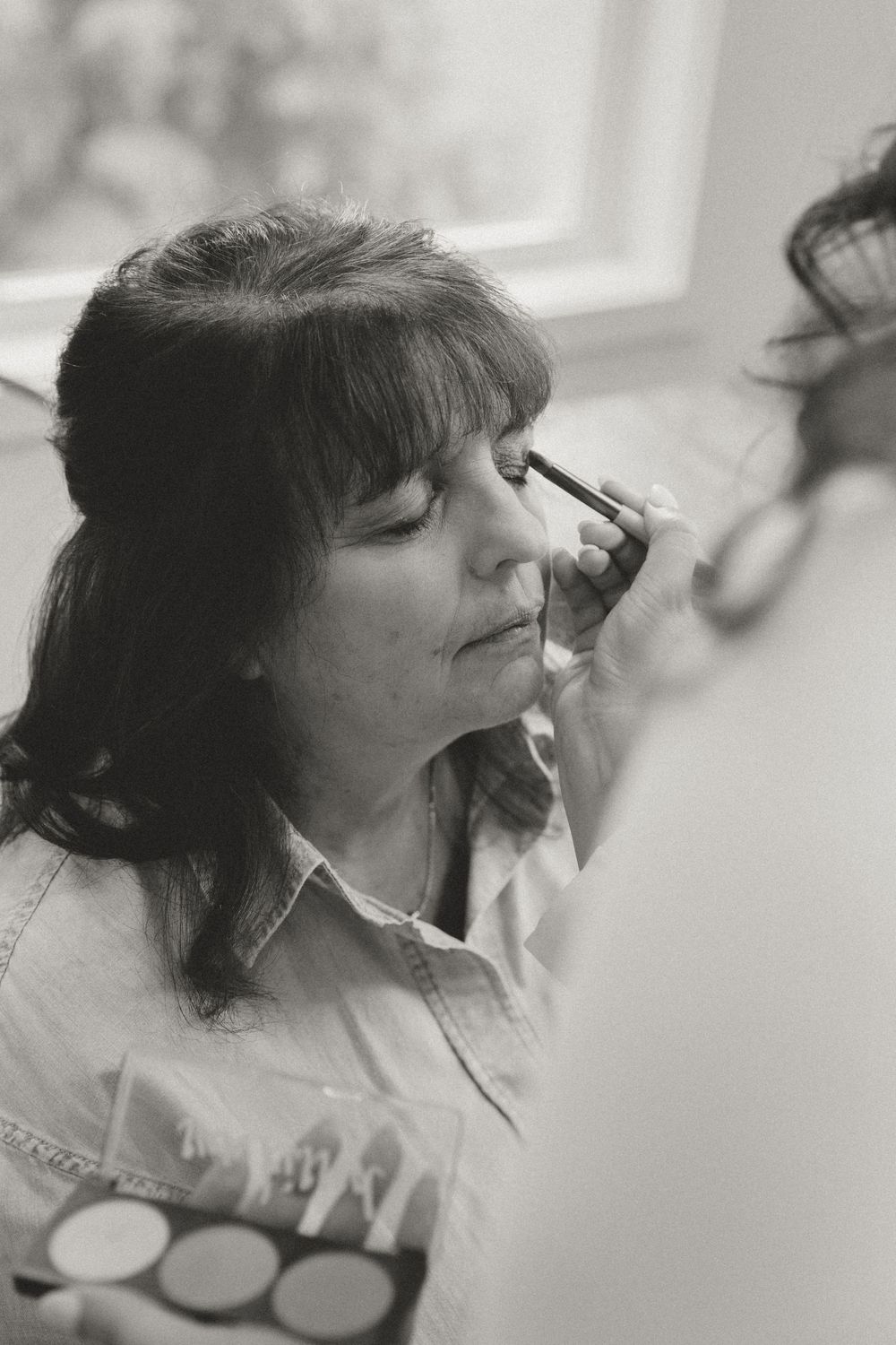 Close-up shots of hair styling preparation in a light-filled space.