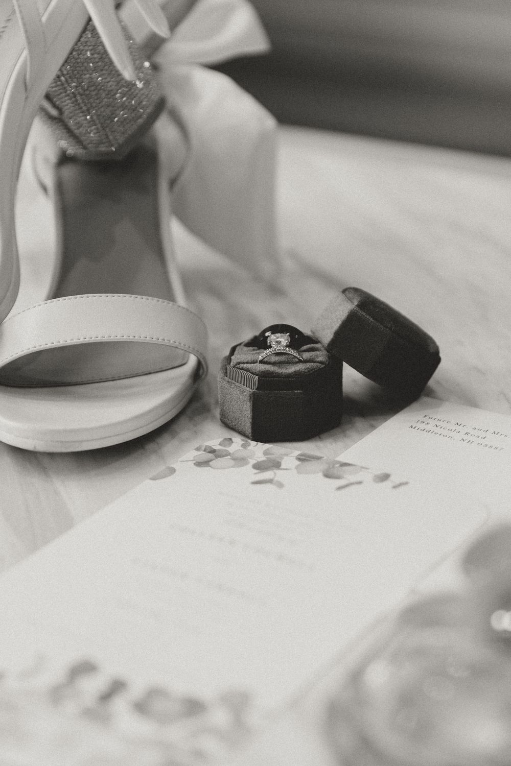 Elegant wedding stationery with white and gray details arranged on a light surface.