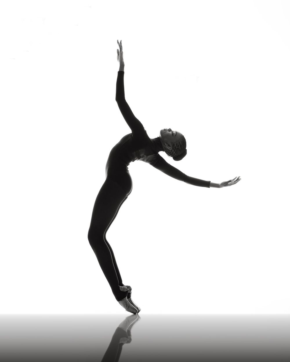 Five silhouetted dancers leaping and posing in an artistic sequence against a bright background.