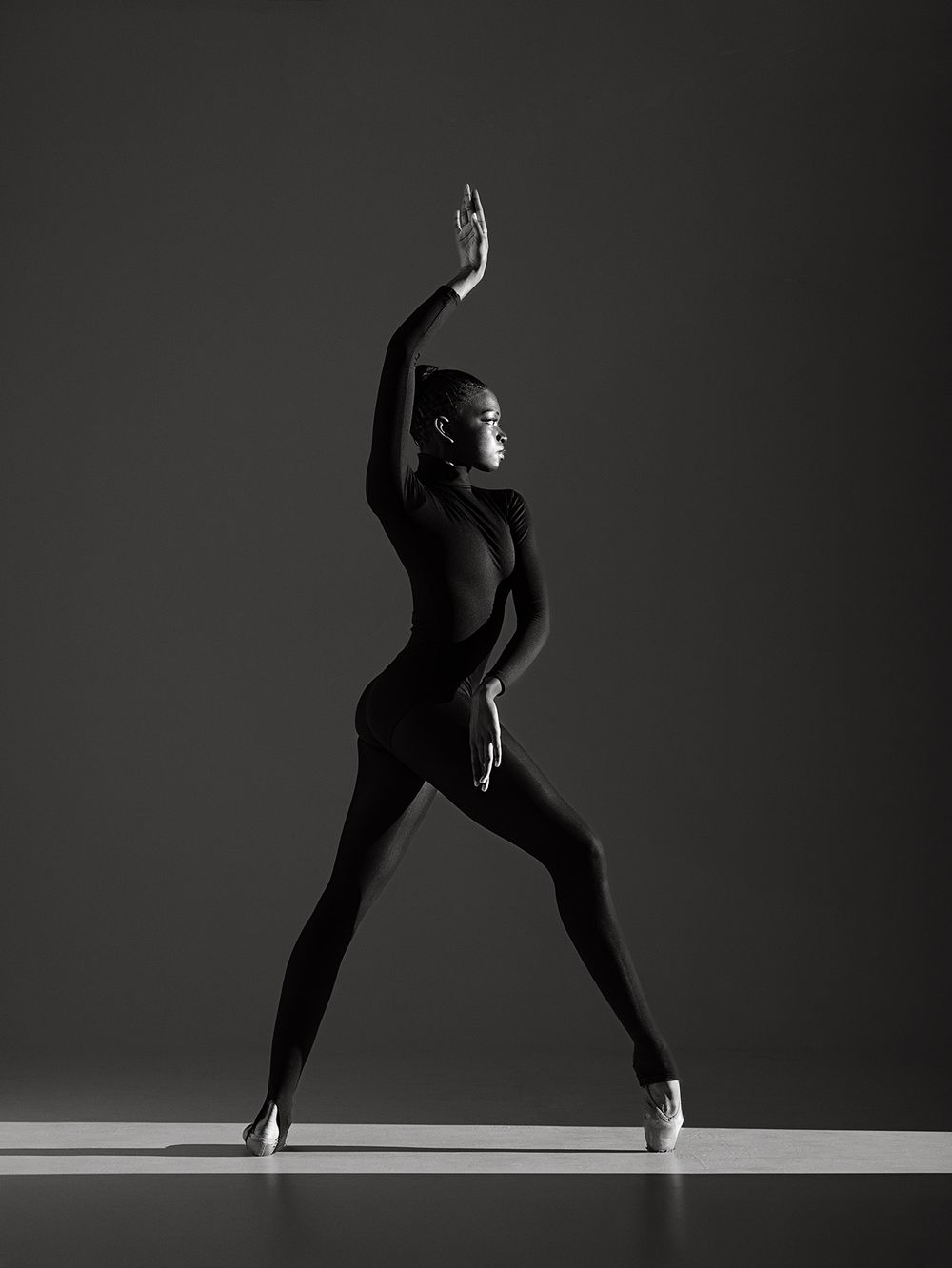 A black and white photo series showing graceful dance movements in silhouette against a minimalist background.