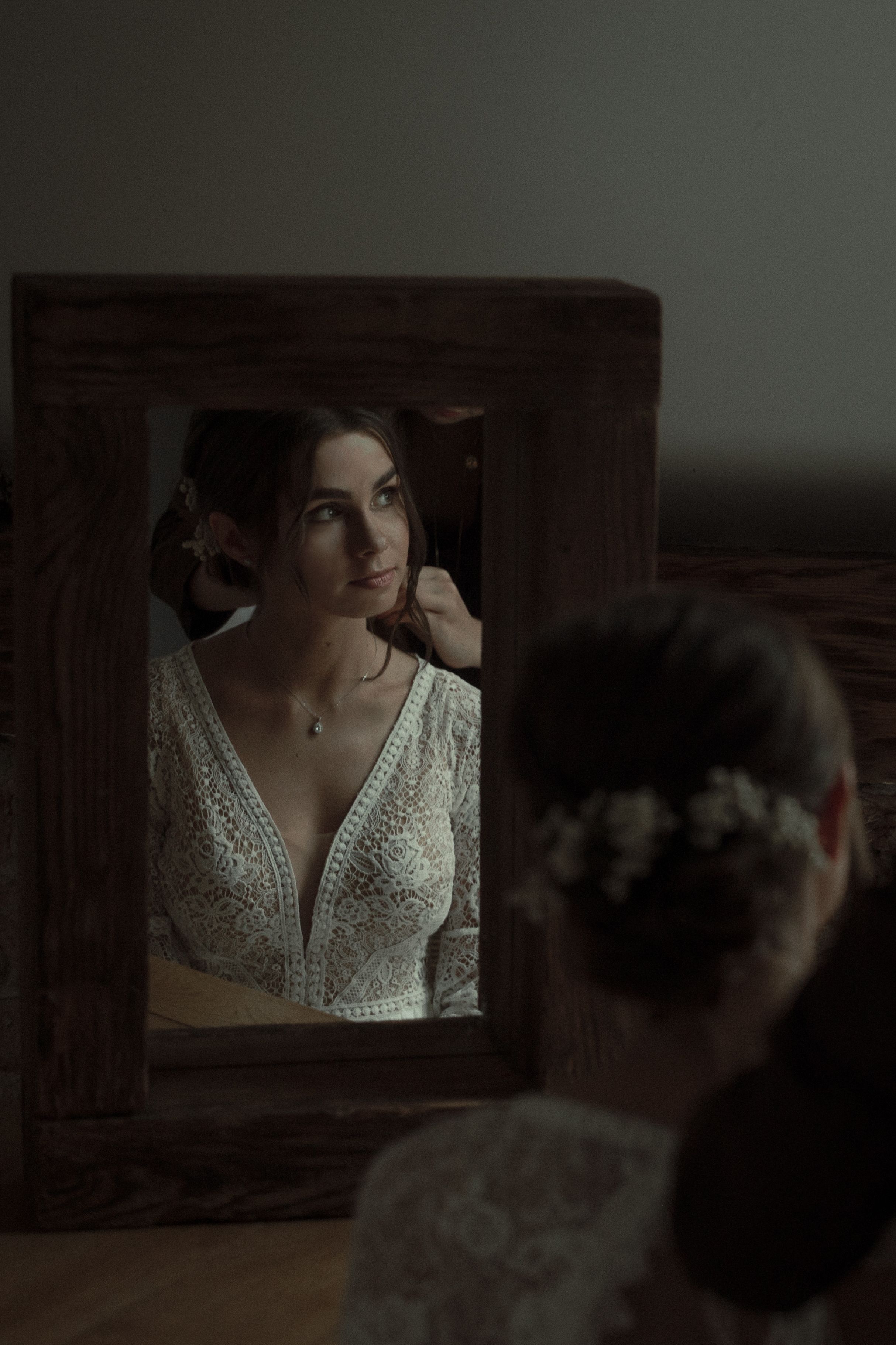 Multiple still frames from a darkly lit scene show someone in a white beaded dress in what appears to be a period setting.