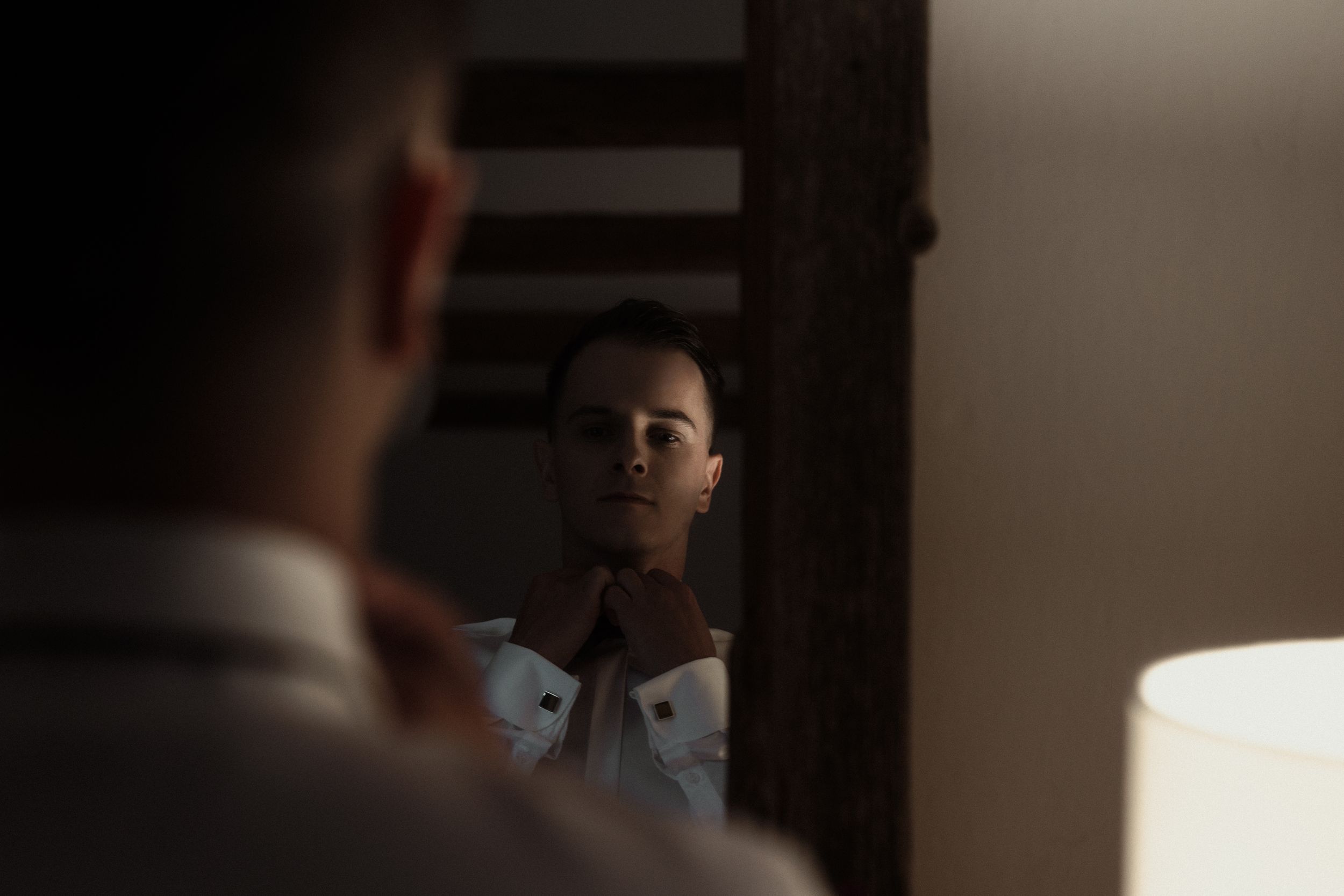 Dramatic film noir sequence showing a silhouetted figure in multiple shadowy frames against dark lighting.