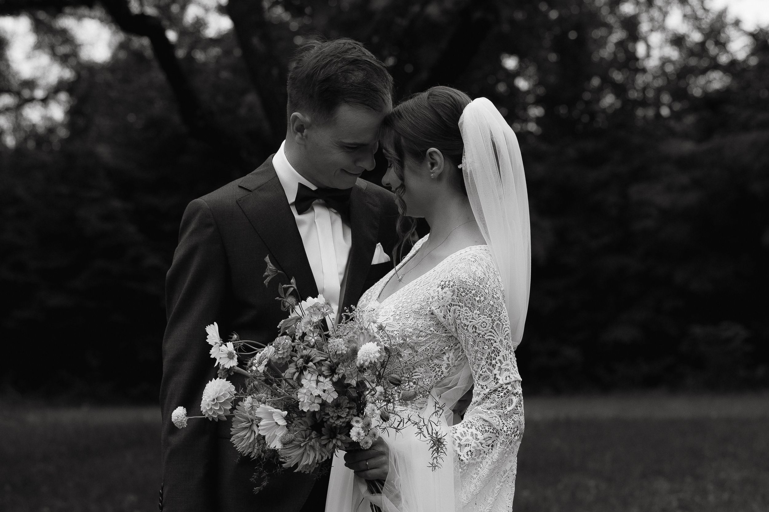 A romantic black and white wedding photo sequence showing tender moments between a bride and groom outdoors.