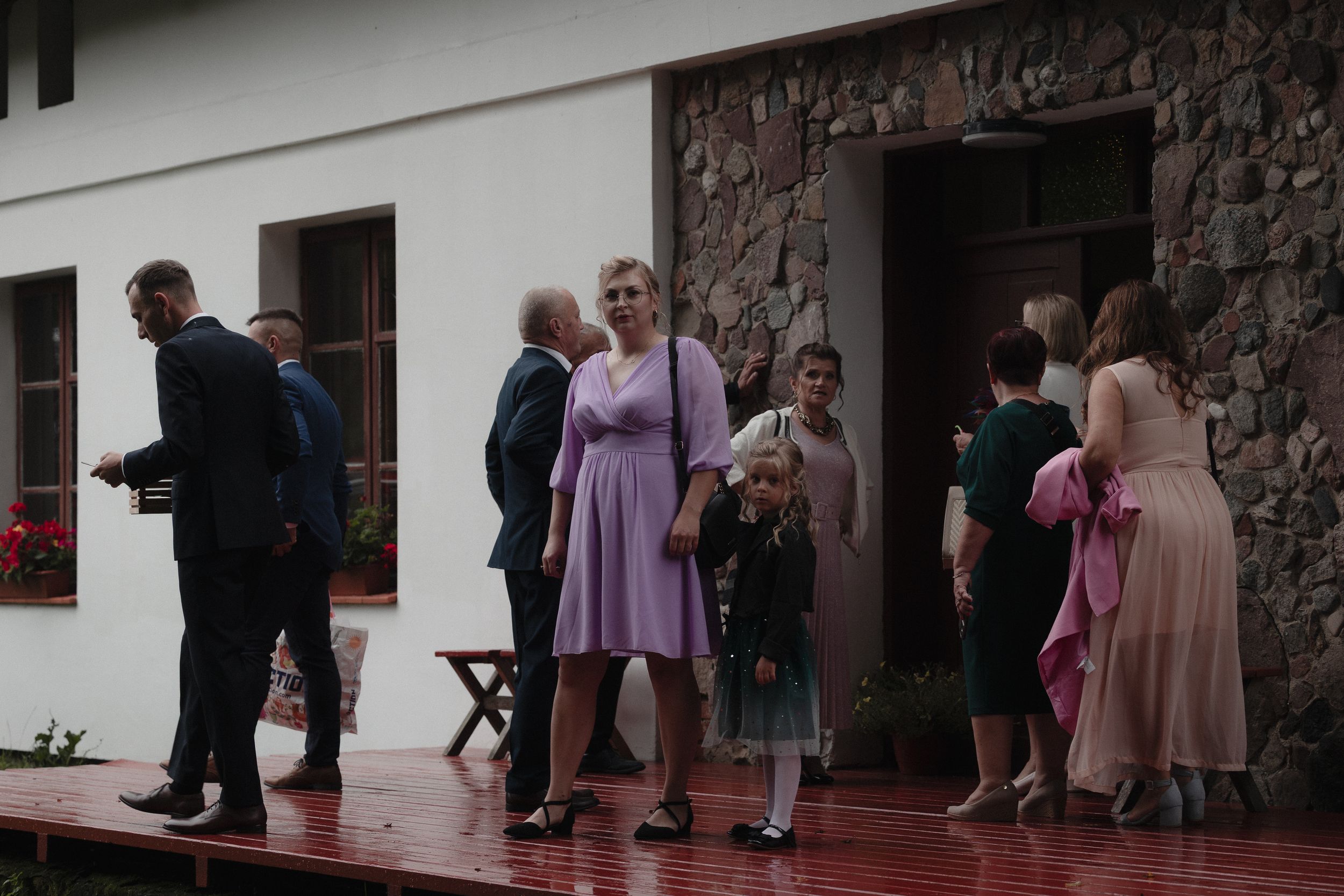 A photo collage shows guests in formal attire arriving at a rustic brick wedding venue entrance.