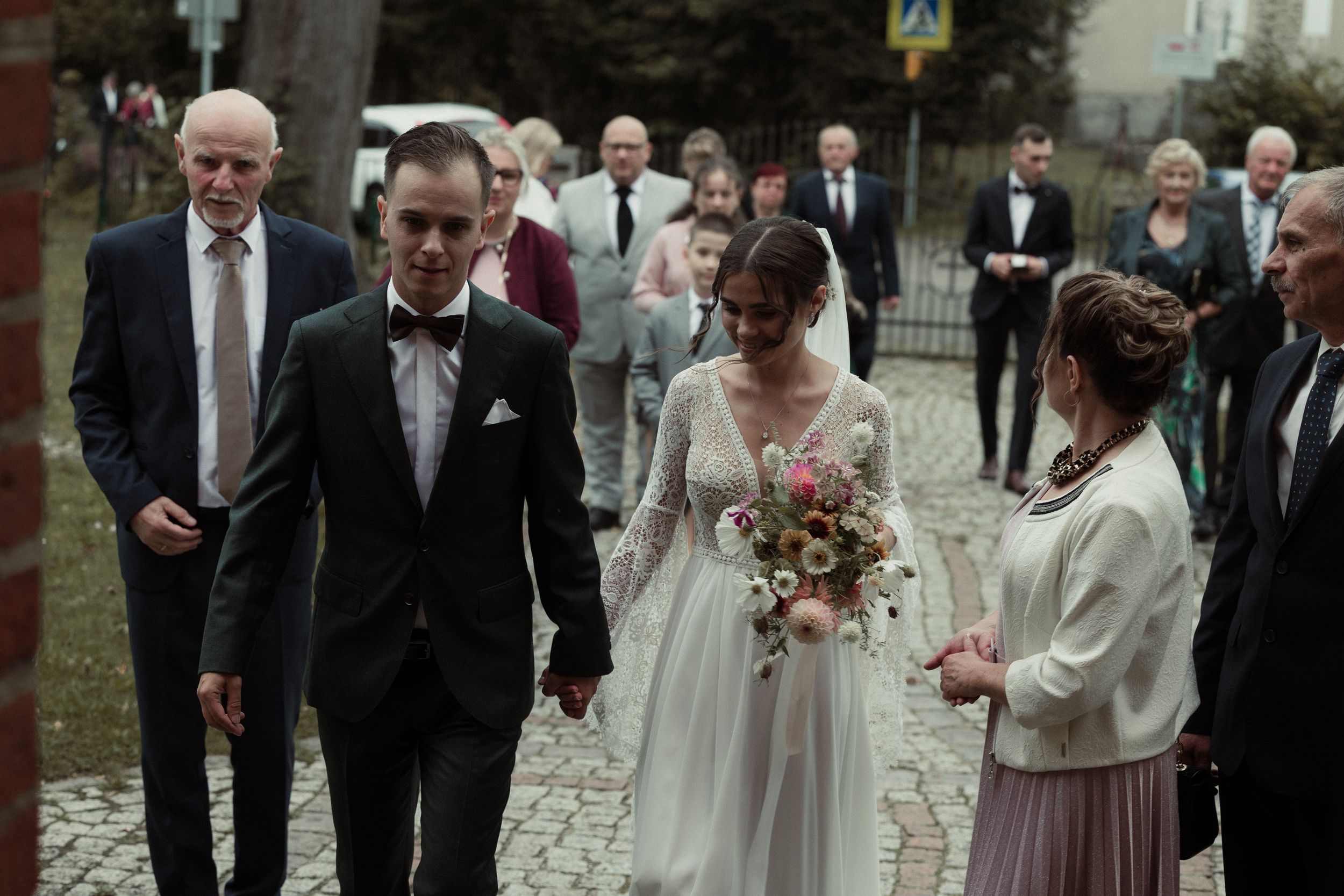A collage of wedding celebration moments showing couples and guests in formal attire gathered at an outdoor venue.