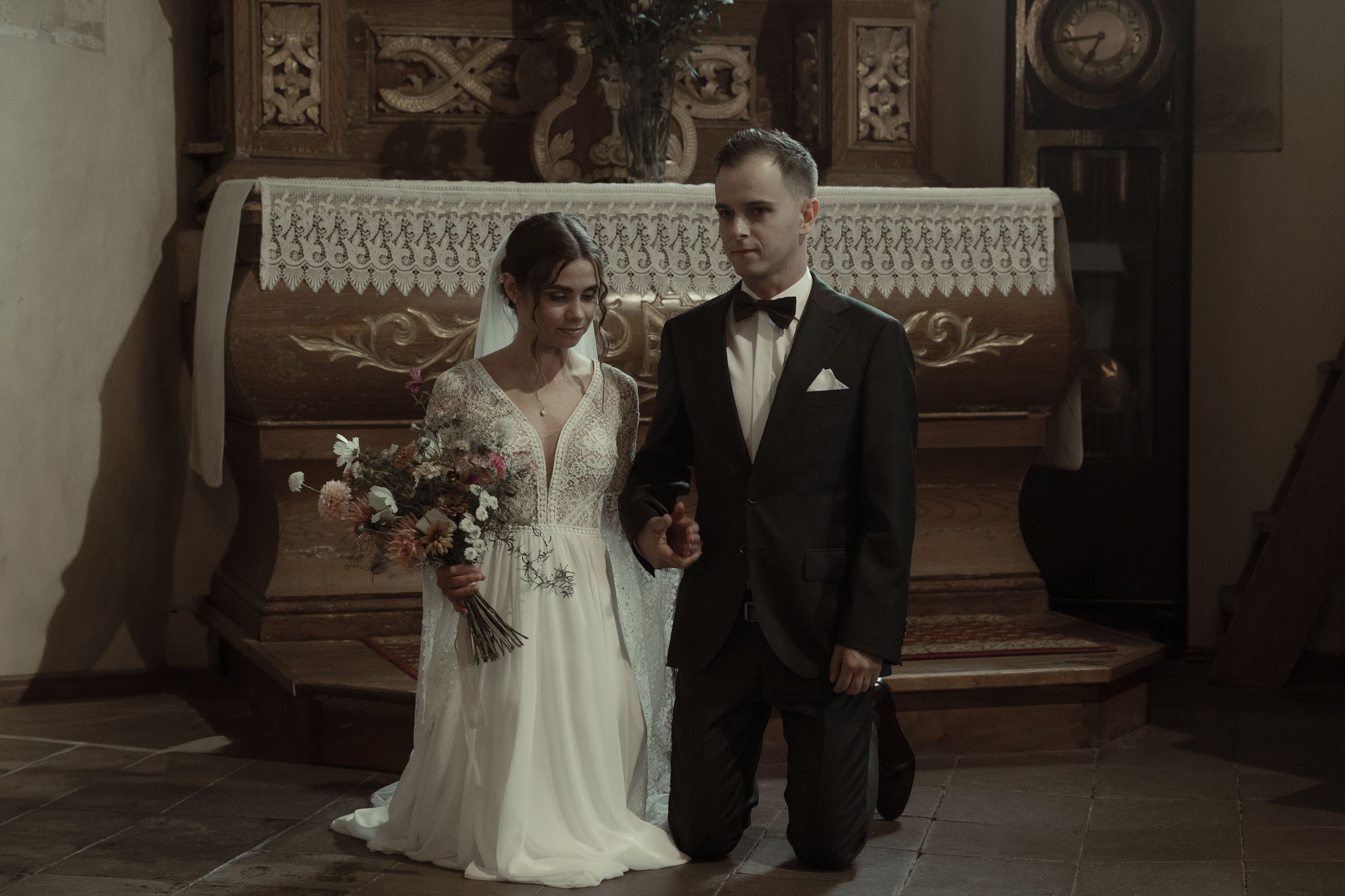 A black and white panoramic image showing a classic wedding scene with ornate architectural details and vintage decor.
