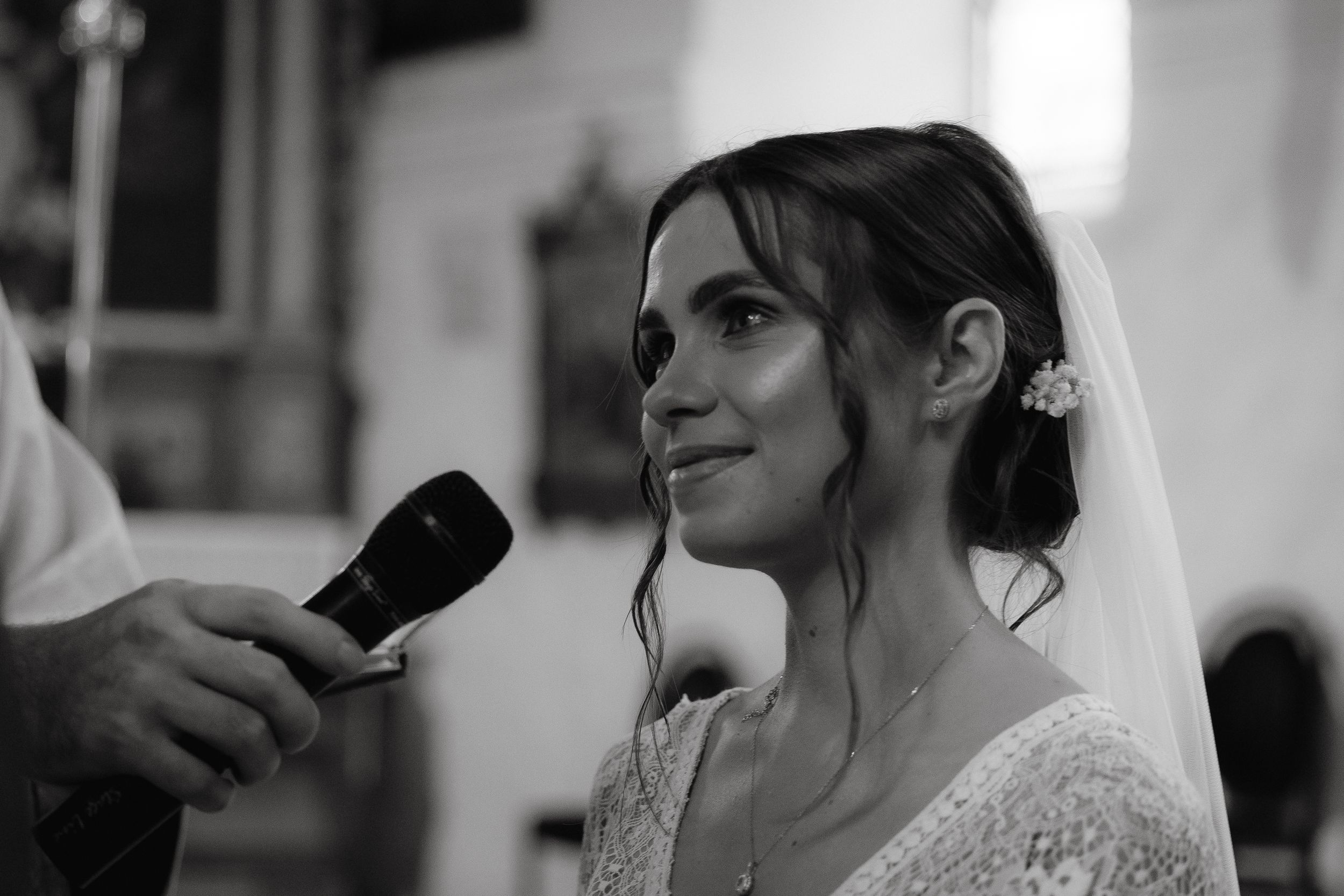 A candid black and white wedding photo series showing emotional moments between the bride and groom.