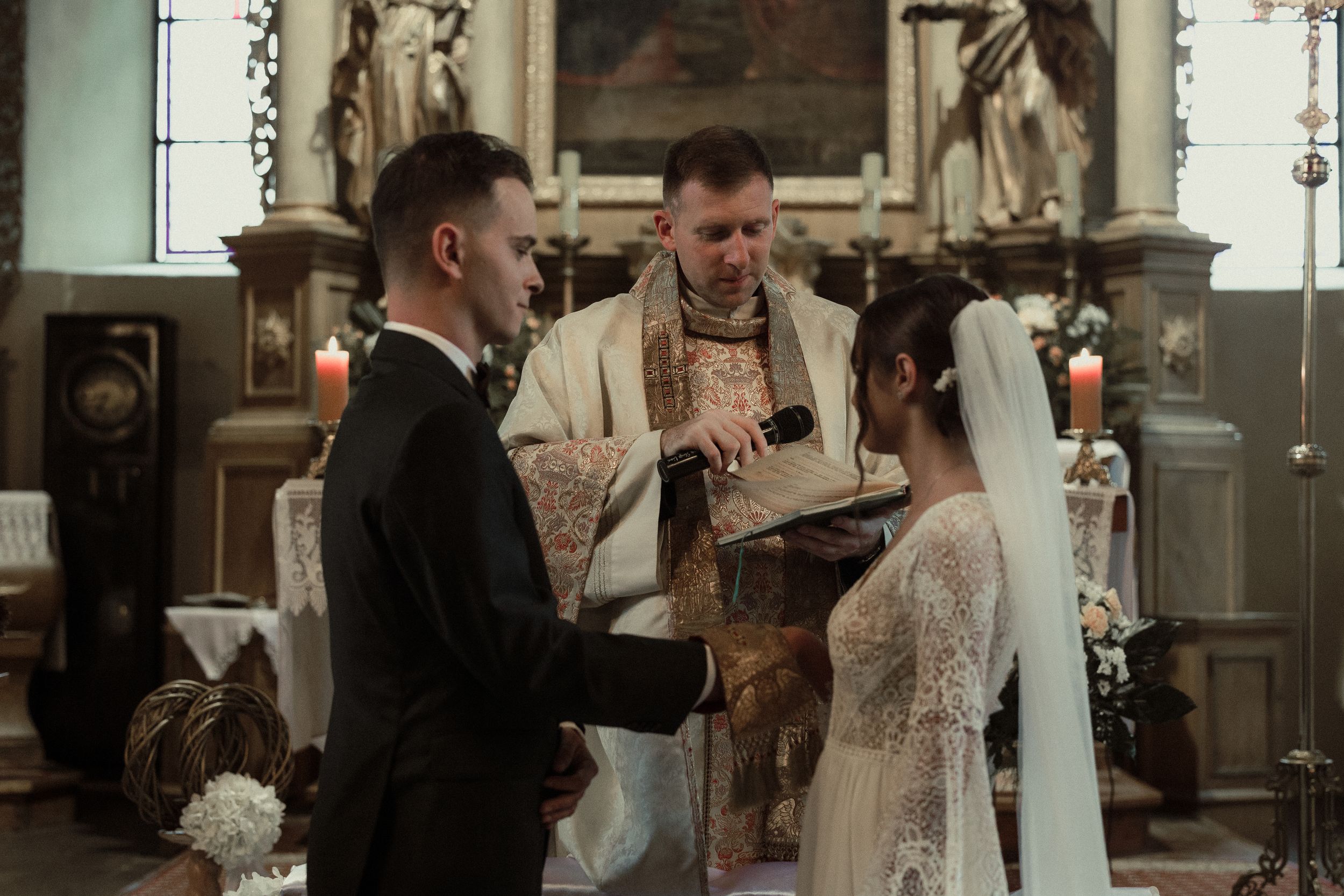 A vintage-inspired wedding ceremony unfolds in a rustic church with soft lighting and floral accents.