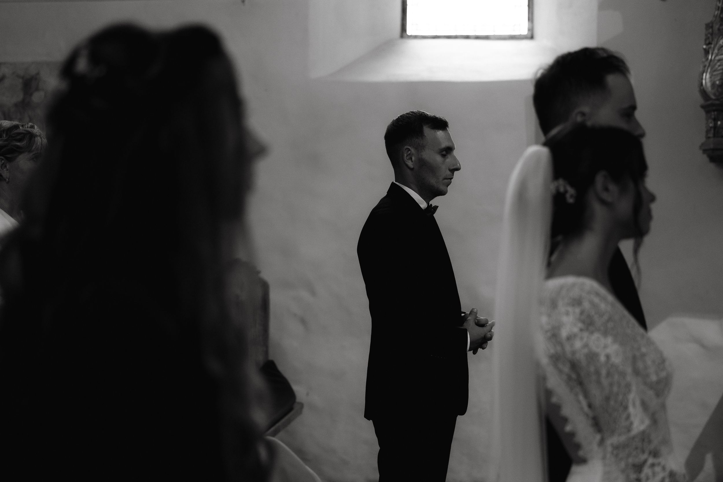 Wedding guests share an intimate dance moment during a reception in black and white.