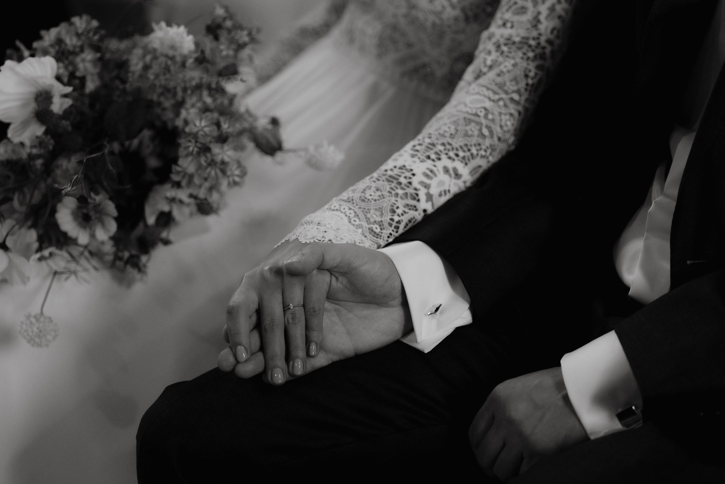 A monochromatic black and white wedding photo montage showing intimate moments between couples and details.
