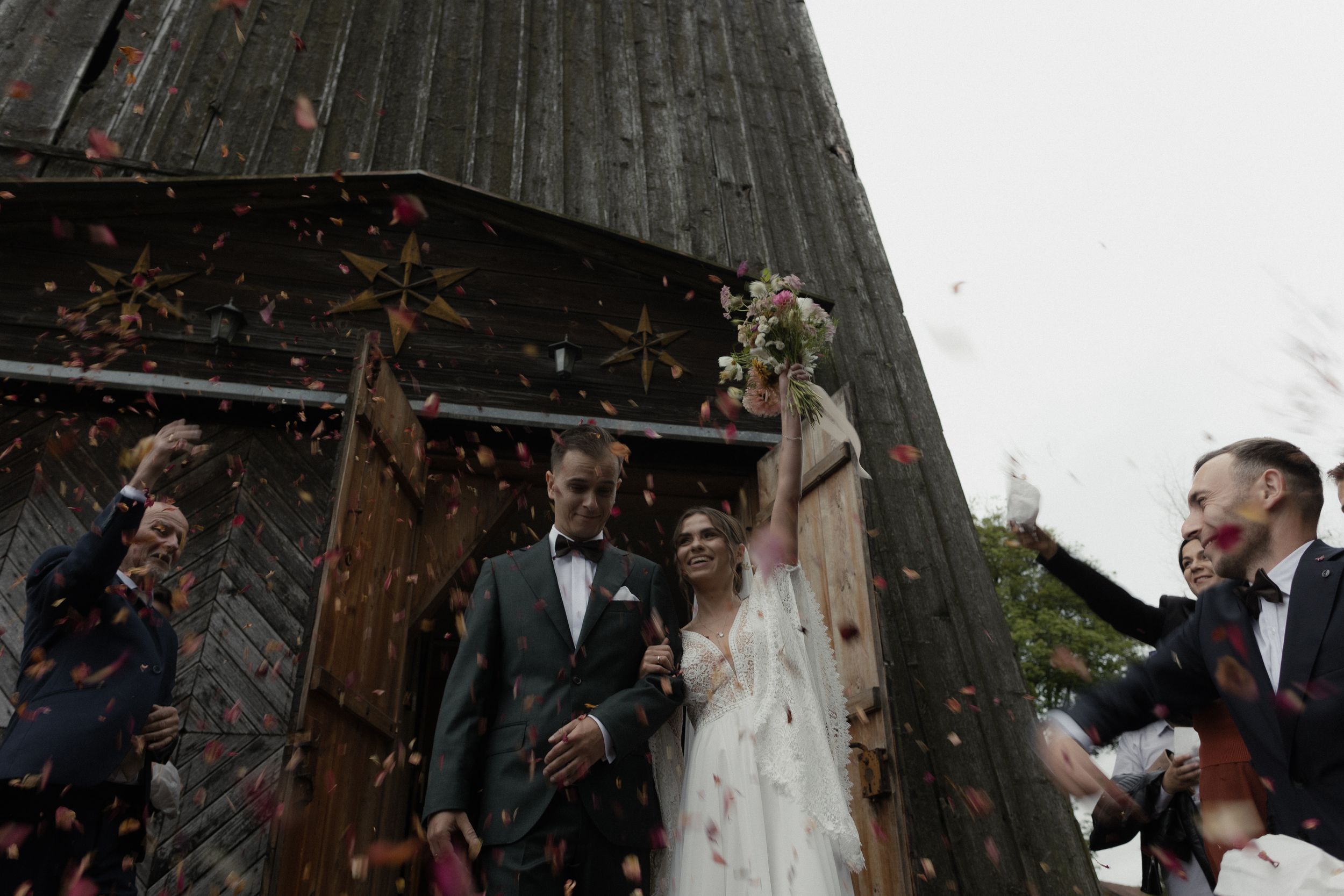 Wedding couple shares a romantic dance moment outdoors at their rustic barn reception venue.