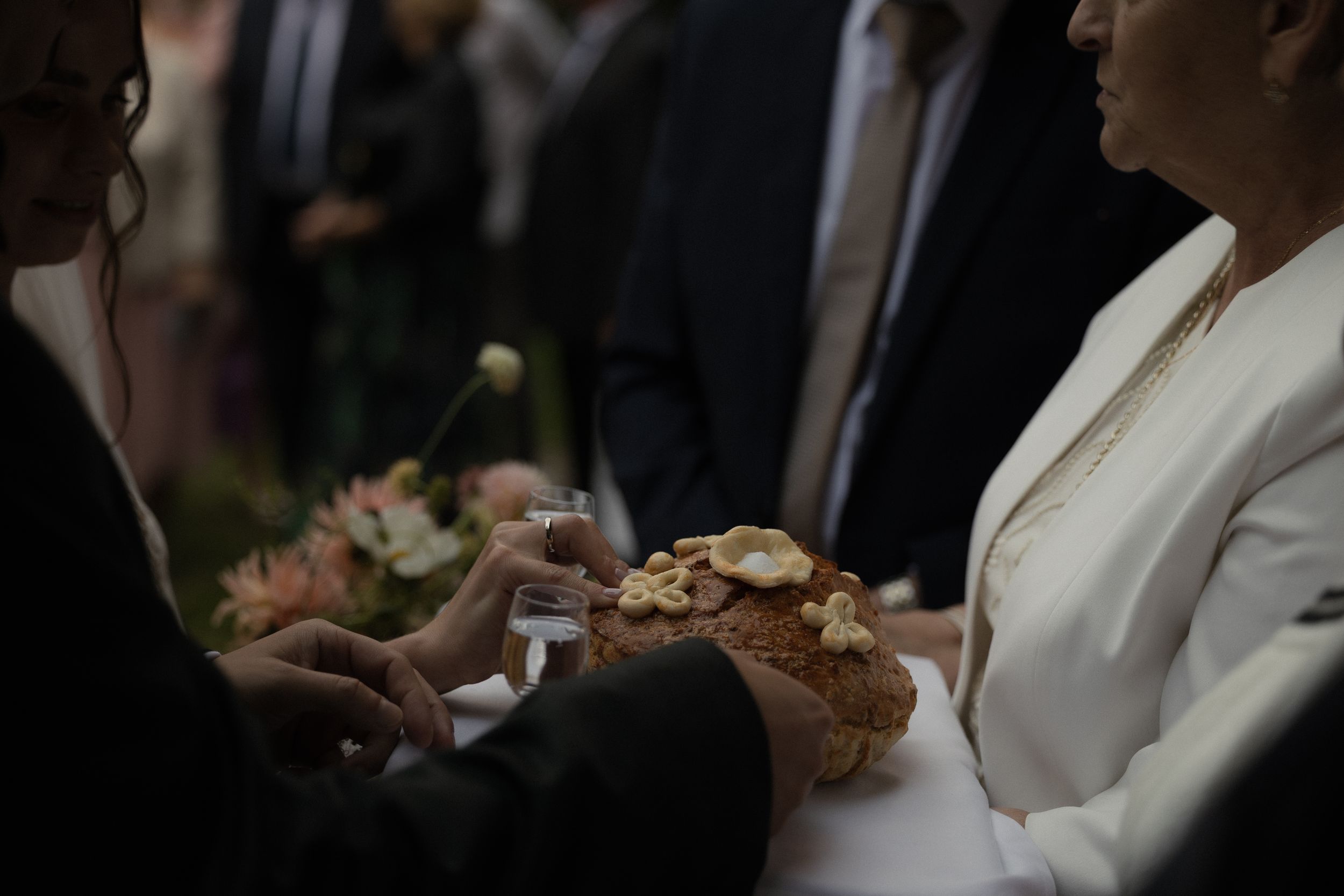 Wedding guests enjoy refreshments and conversation during an elegant outdoor celebration.