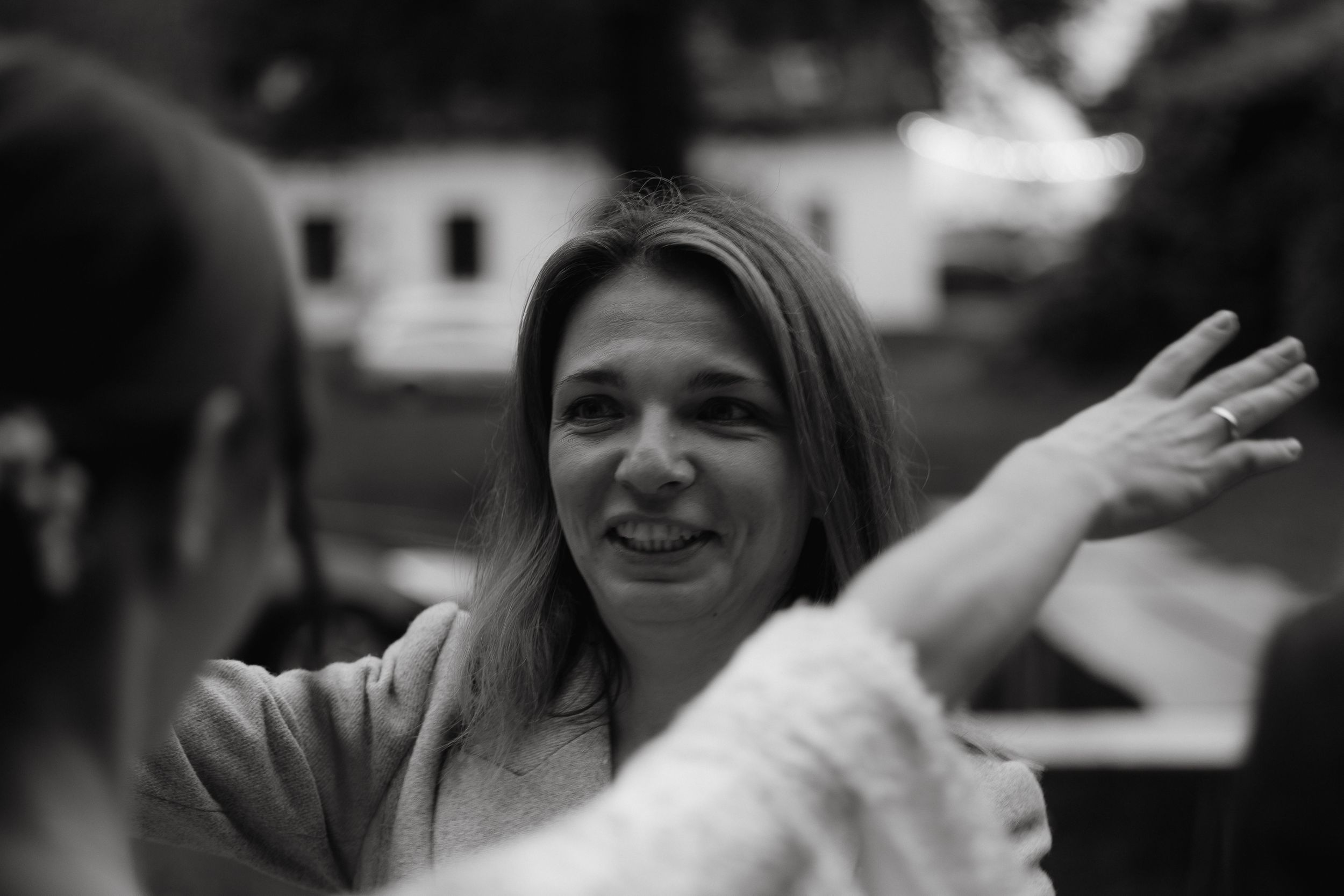 A series of black and white photos showing people in conversation at what appears to be a social gathering.