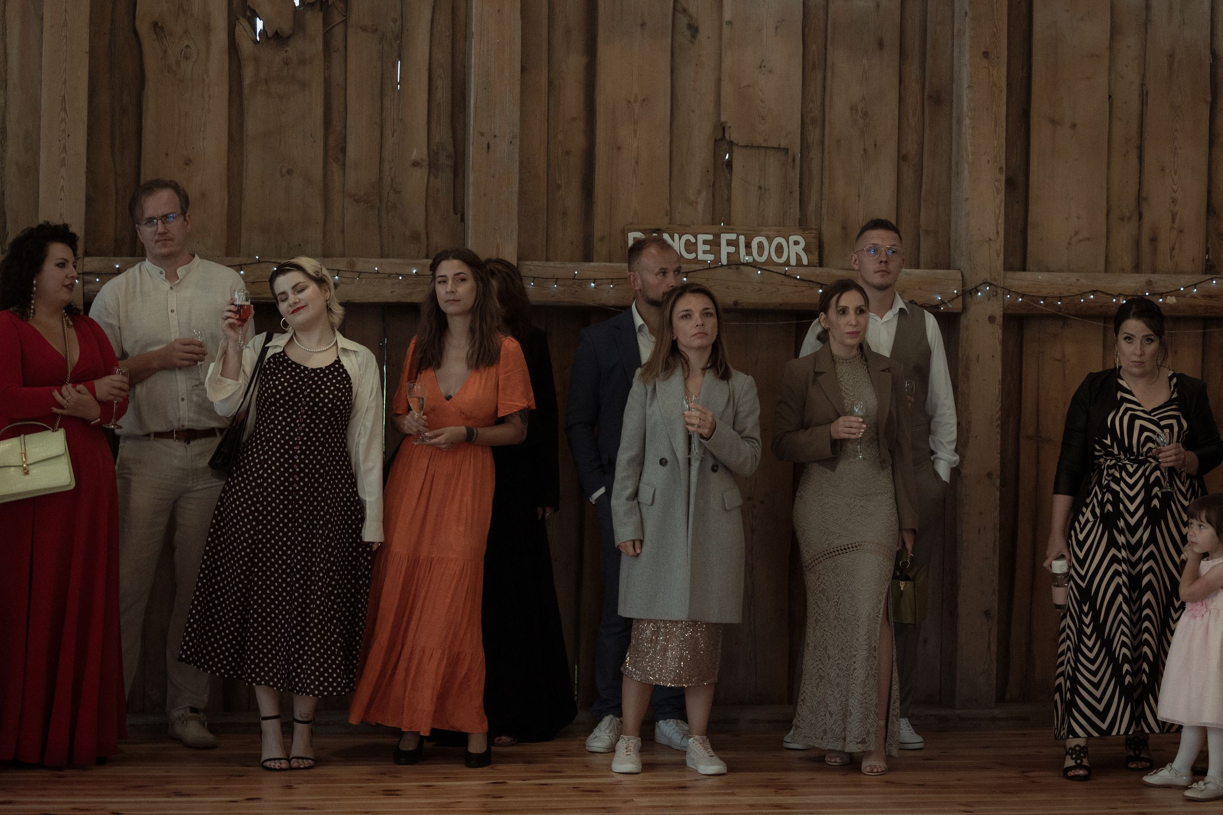 A group of performers take a bow on wooden stage after their theatrical performance at a community theater.