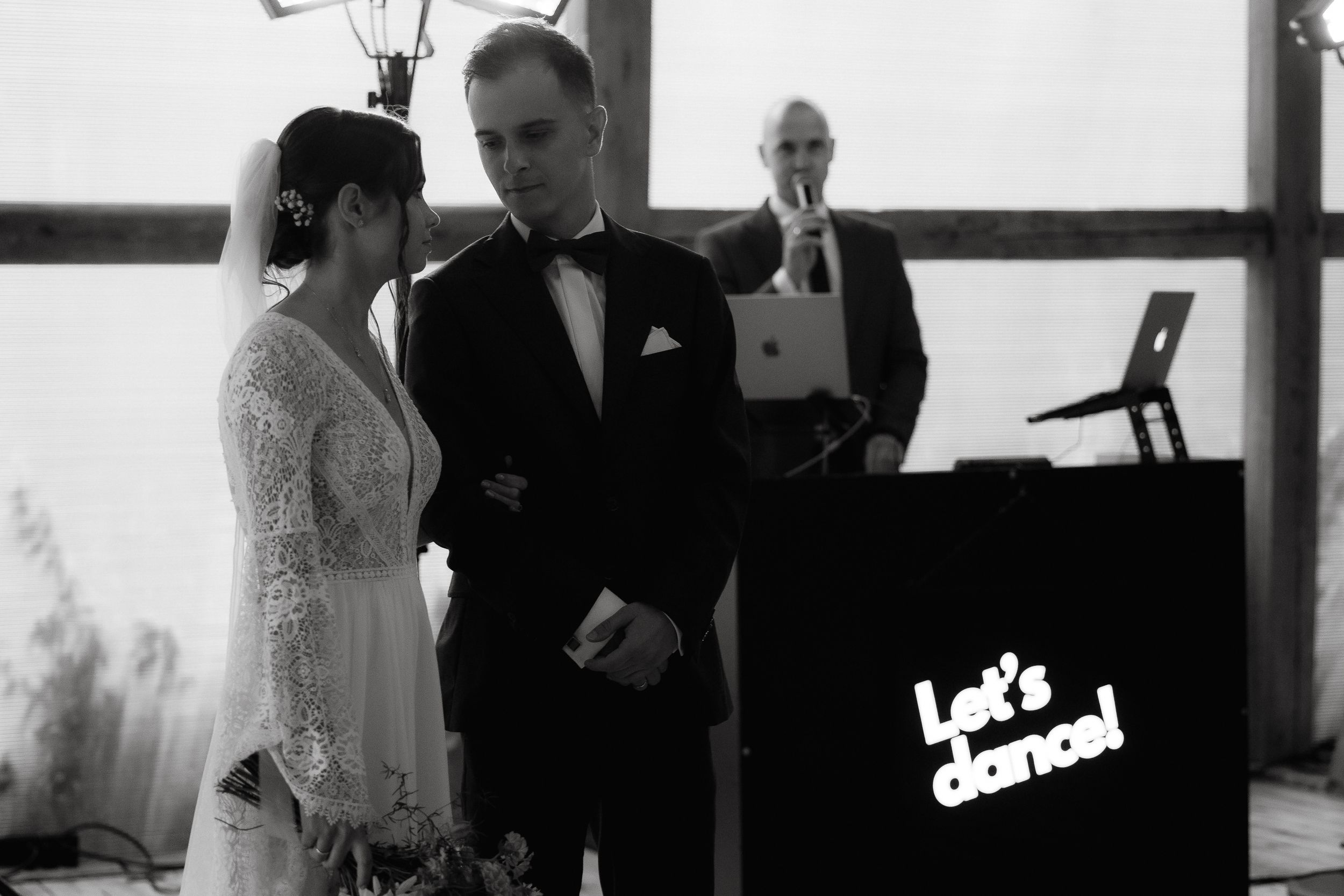 A wedding photographer captures intimate moments at an elegant reception through their camera lens.