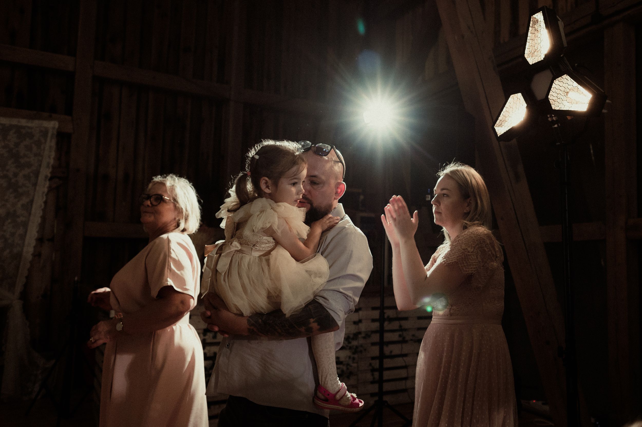 Dimly lit dance floor captures intimate wedding moments during a reception celebration.