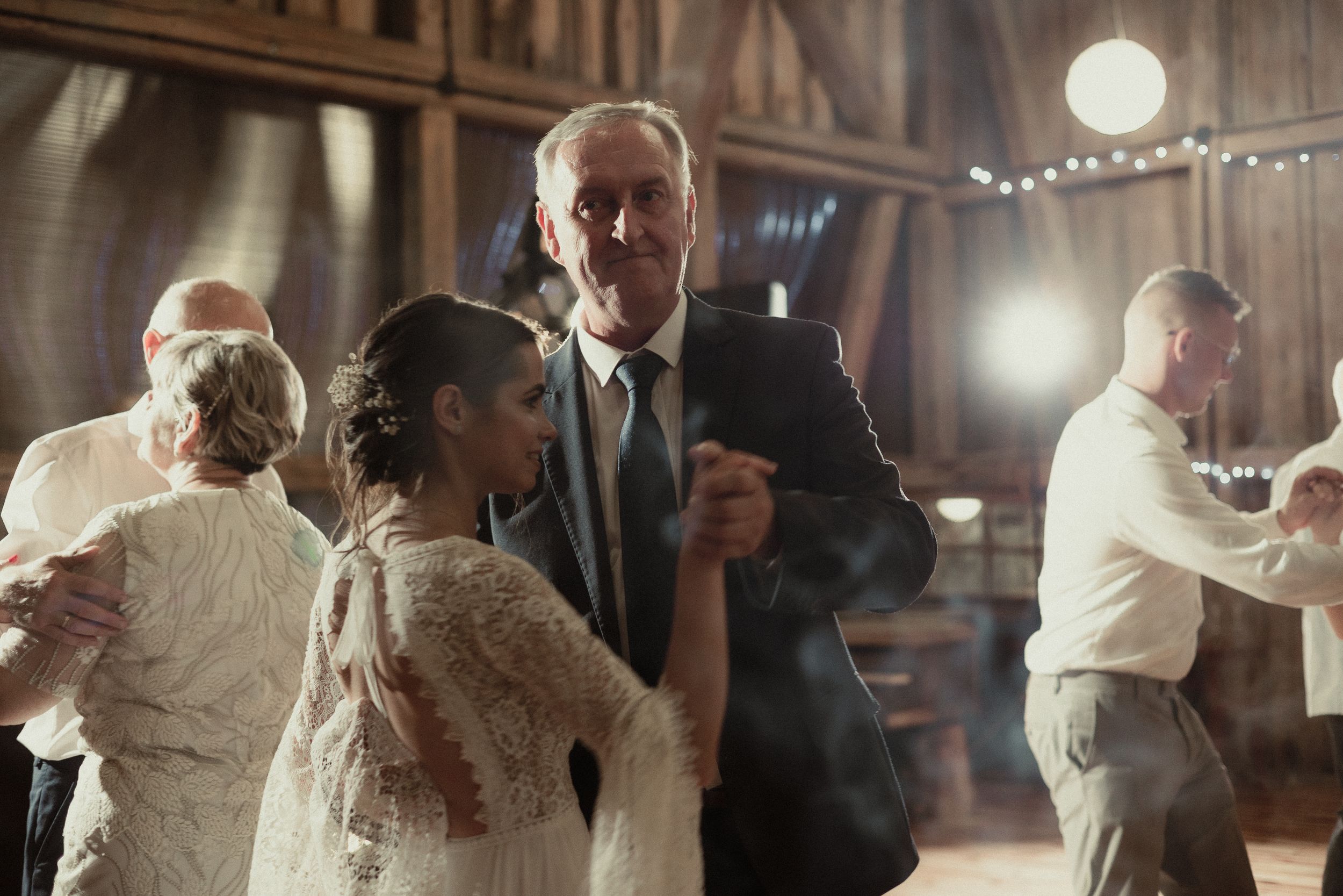 Montage of couples dancing at an elegant evening wedding reception with warm lighting and string lights overhead.