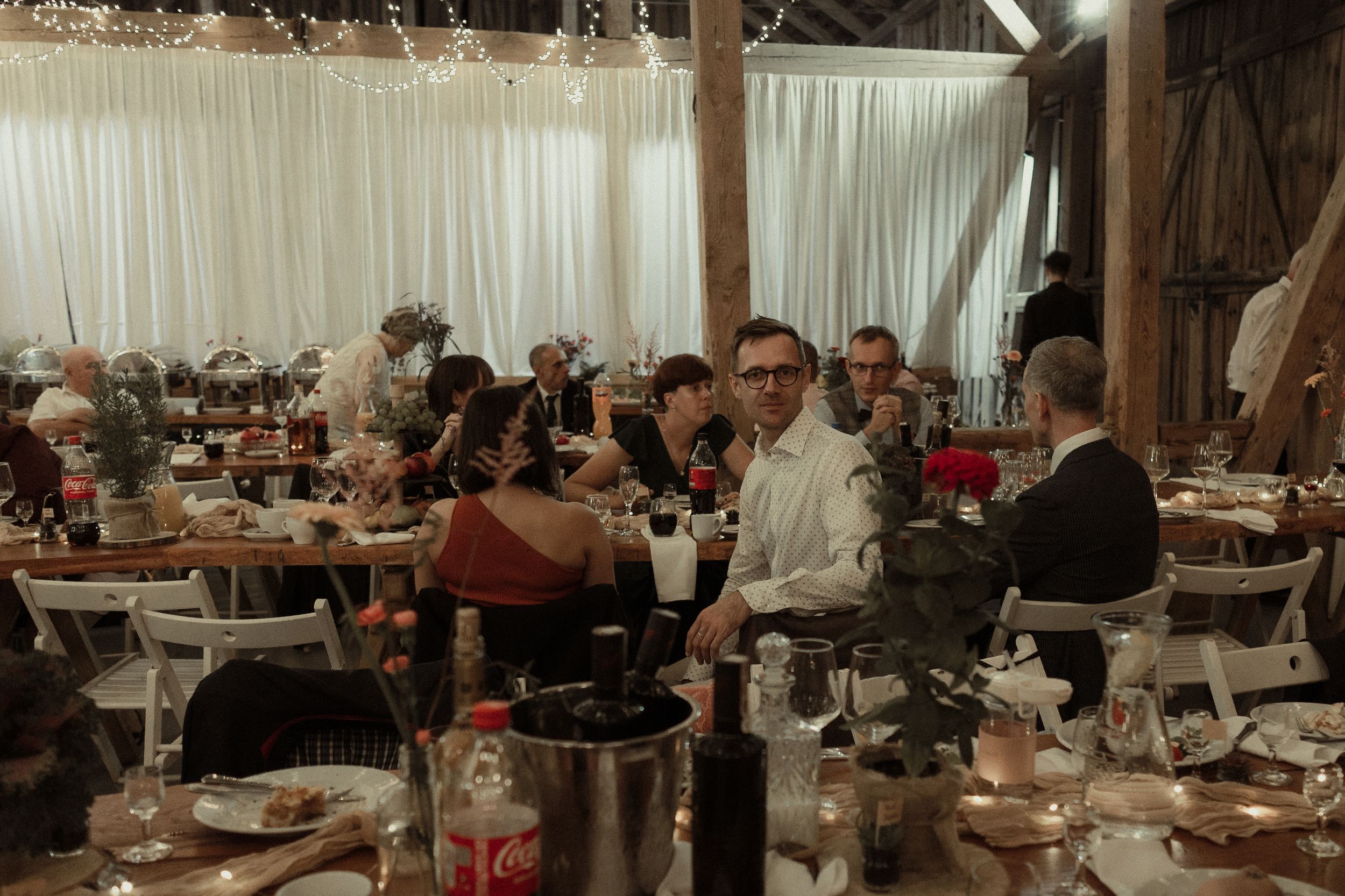 Interior view of an elegant banquet hall with formal dining tables set for a large gathering.