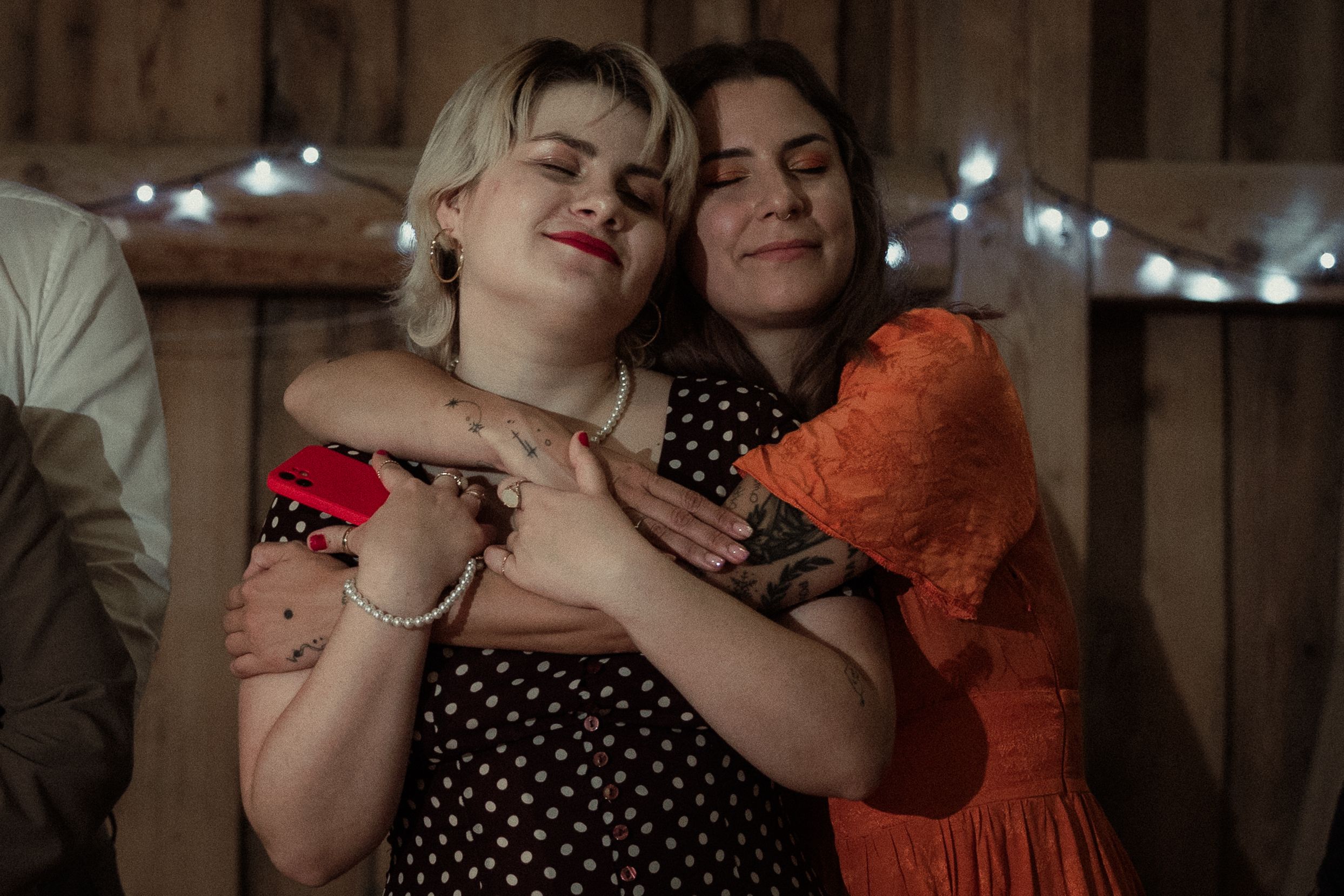 A series of warm-toned romantic close-up portraits of a couple embracing and dancing together indoors.