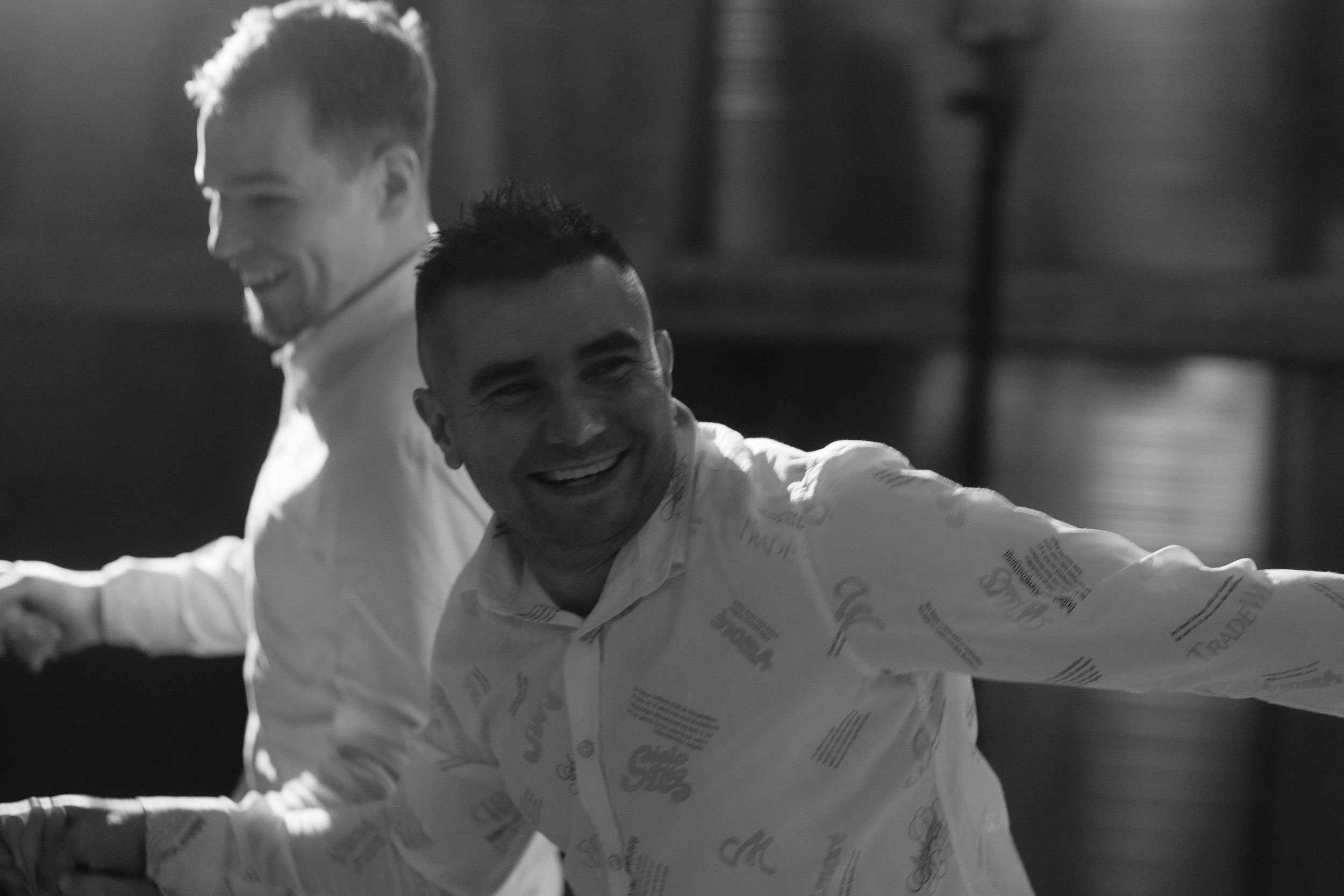 Seven black and white candid photos show people engaged in various party activities and conversations.