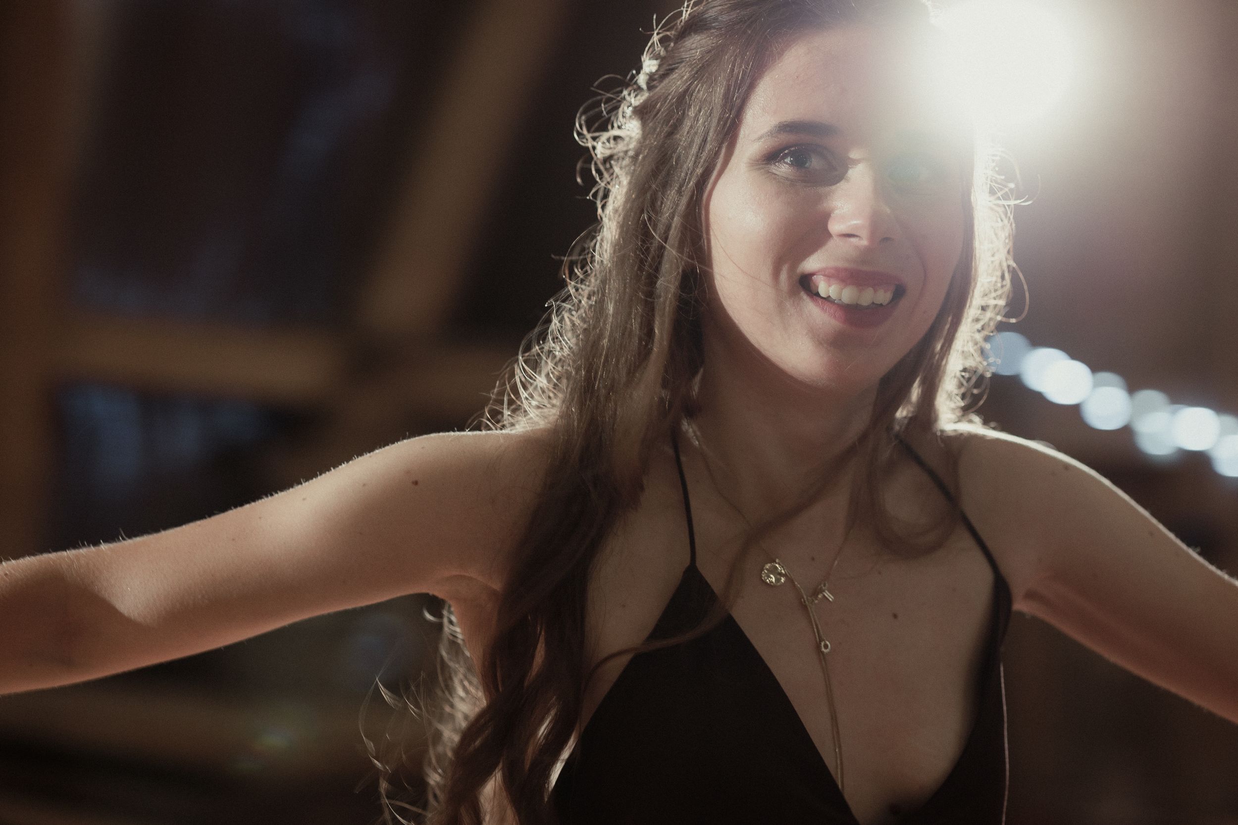 A sequence of professional headshots showing someone smiling naturally against a dark background.