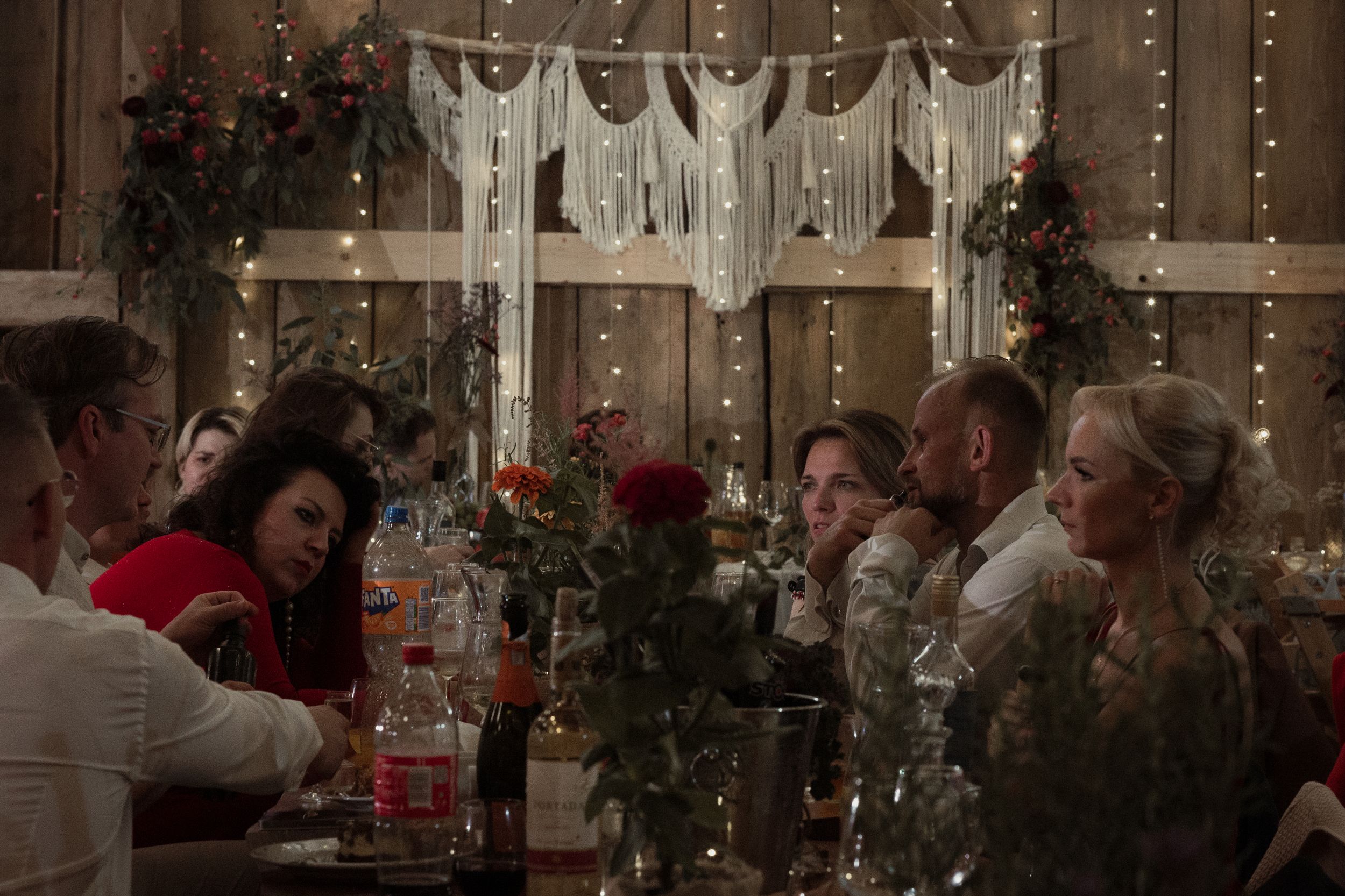 String lights and decor create a warm ambiance in this indoor gathering space during a winter holiday celebration.