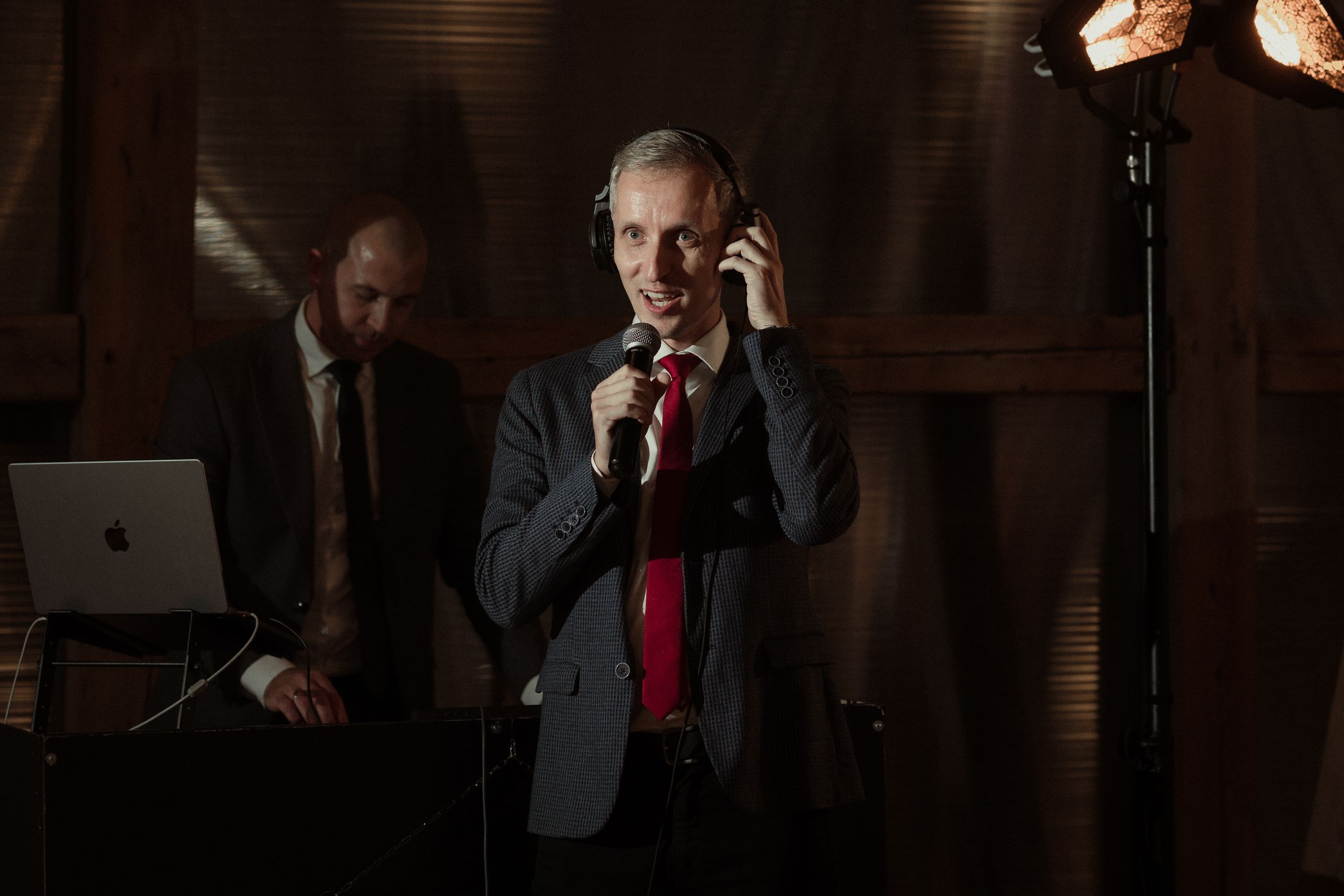 Business professionals working in office settings using phones and laptops in dark ambient lighting.