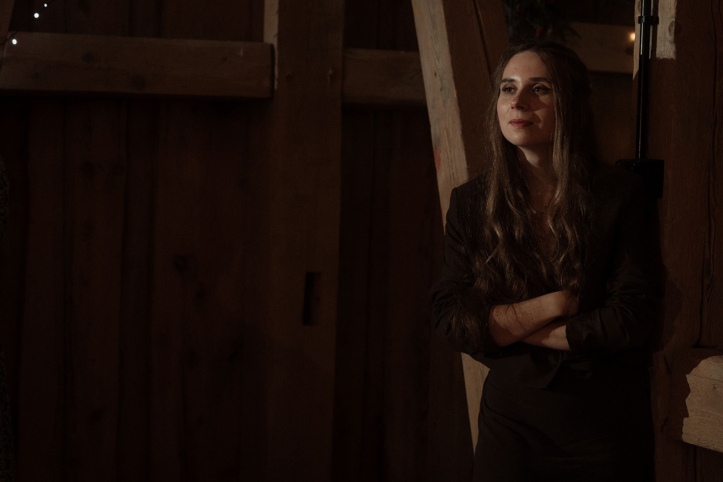 Four dark artistic portraits showing moody lighting and dramatic shadows in a photo studio setting.
