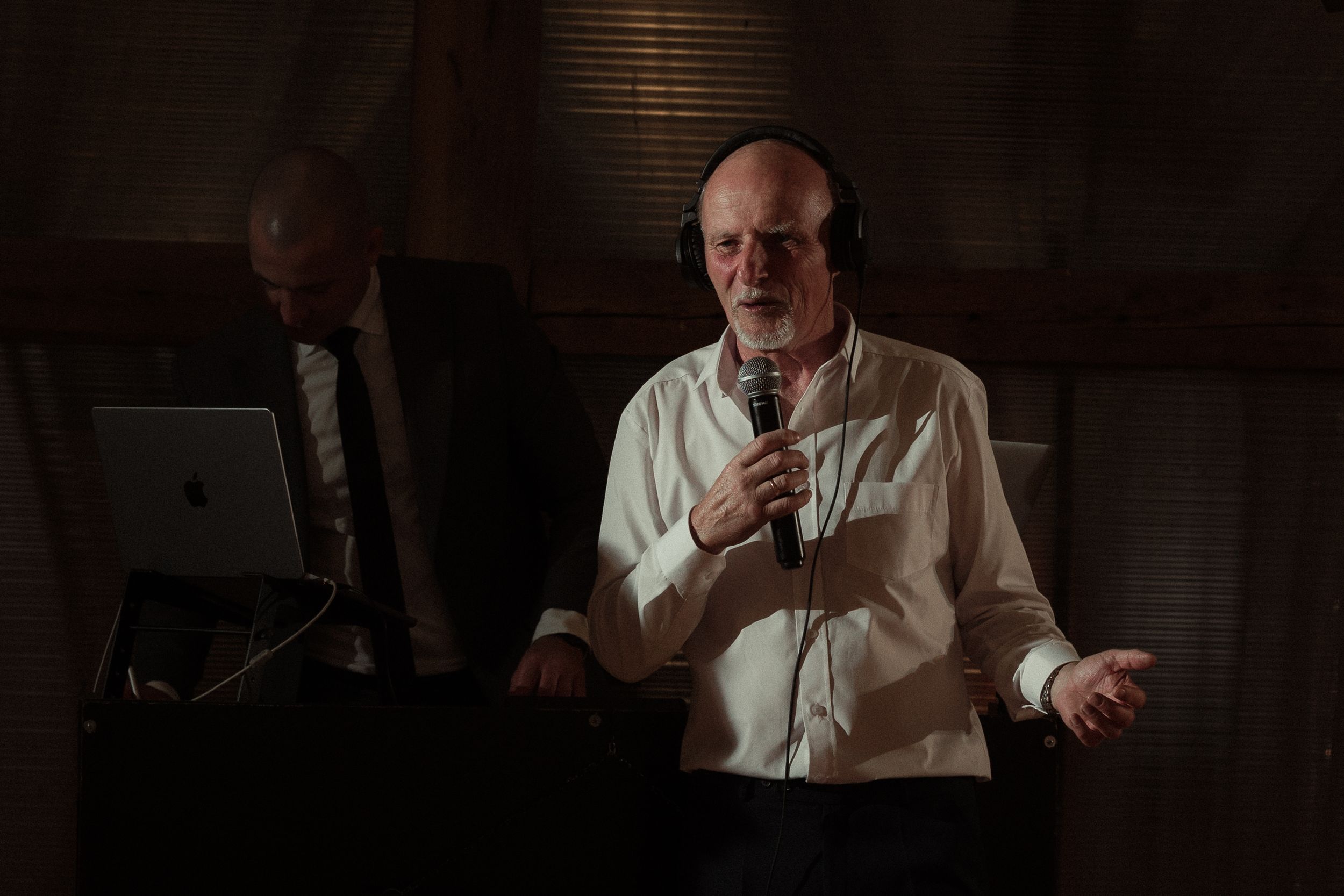 Several shots in sequence show someone in a white shirt moving while sitting in a dark-lit room.