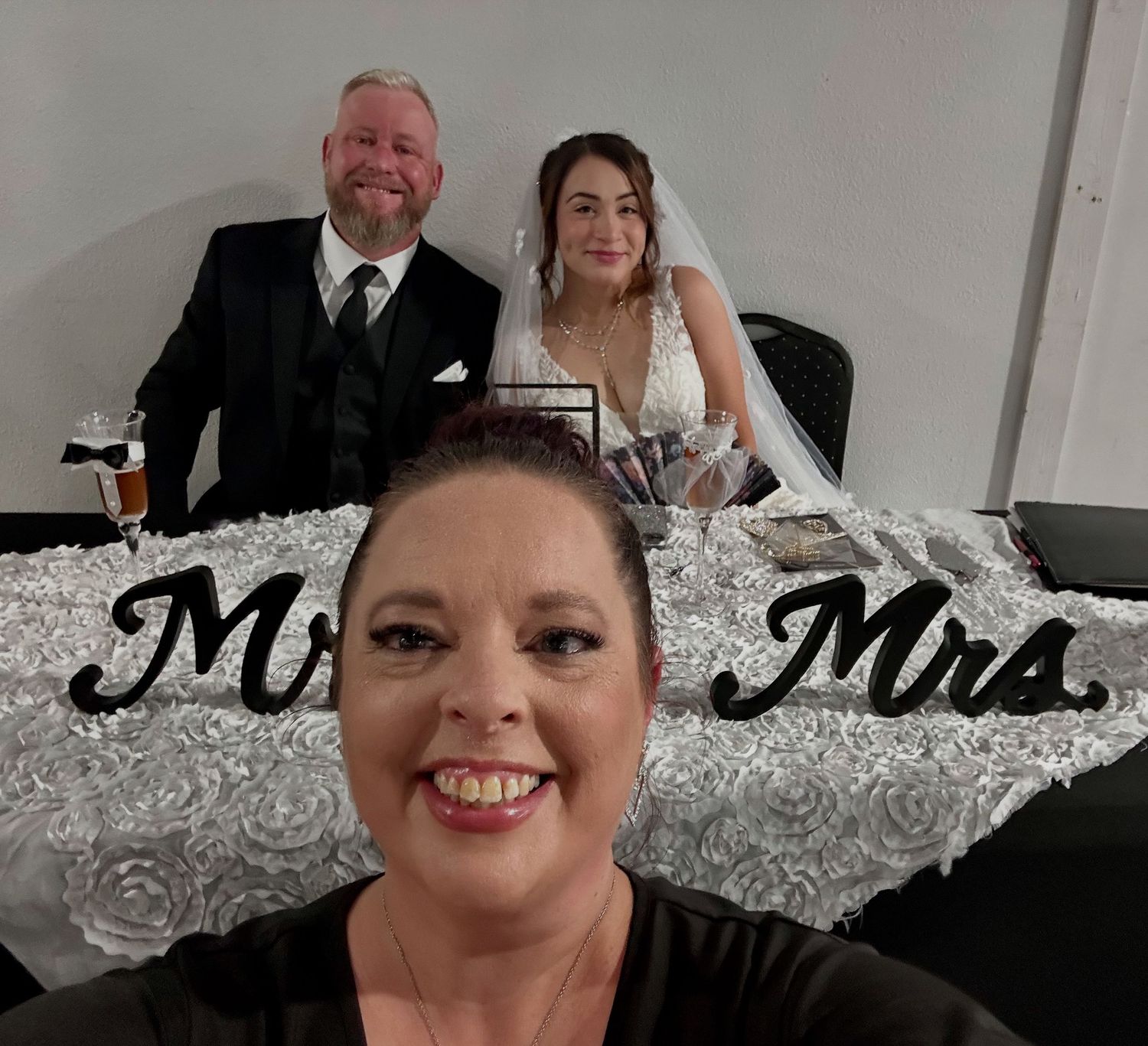 Three monochrome portrait photos from what appears to be a formal wedding event with bright smiles and formal attire.