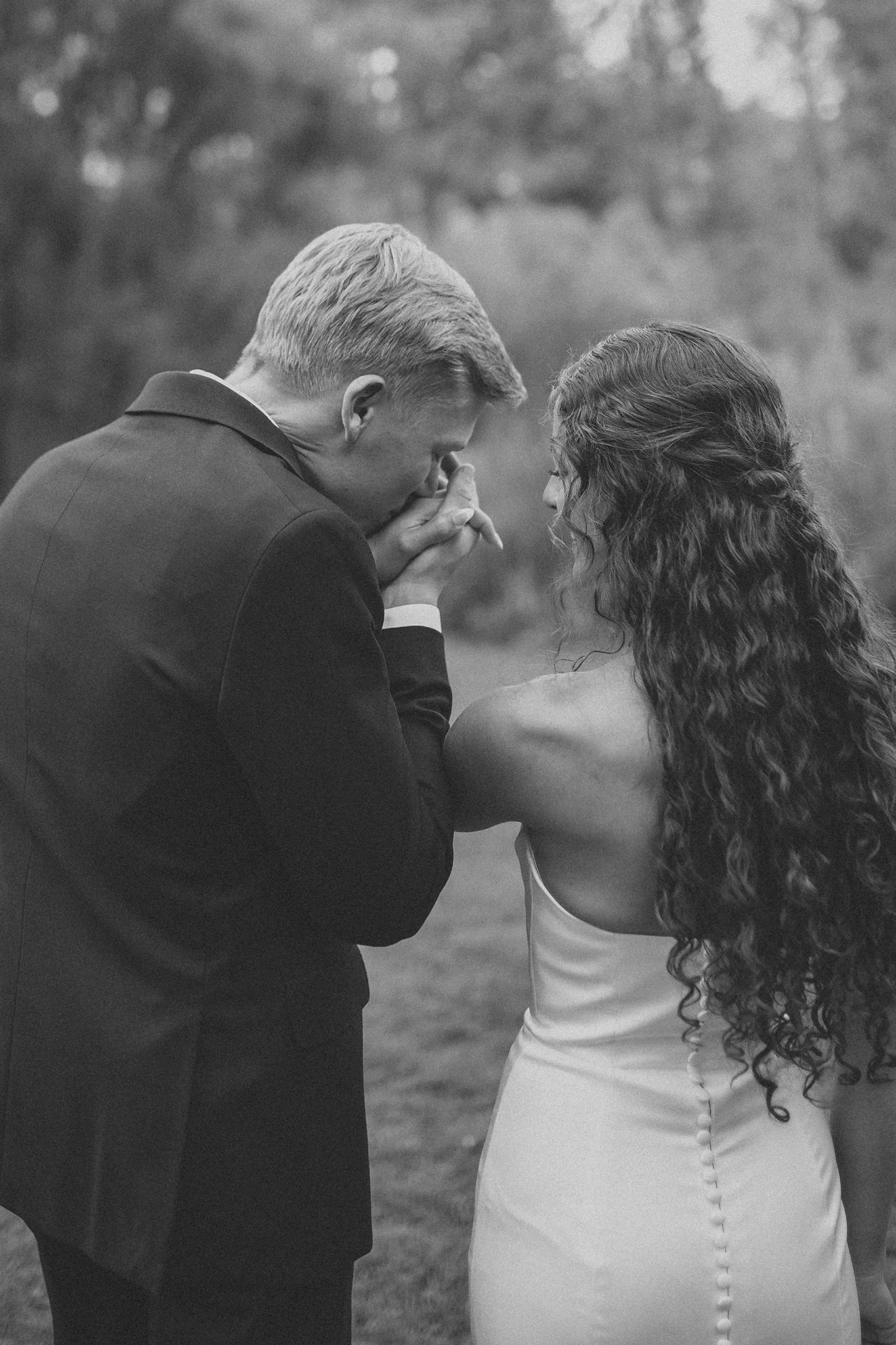 Bride and groom celebrating their North Idaho field wedding surrounded by natural scenery