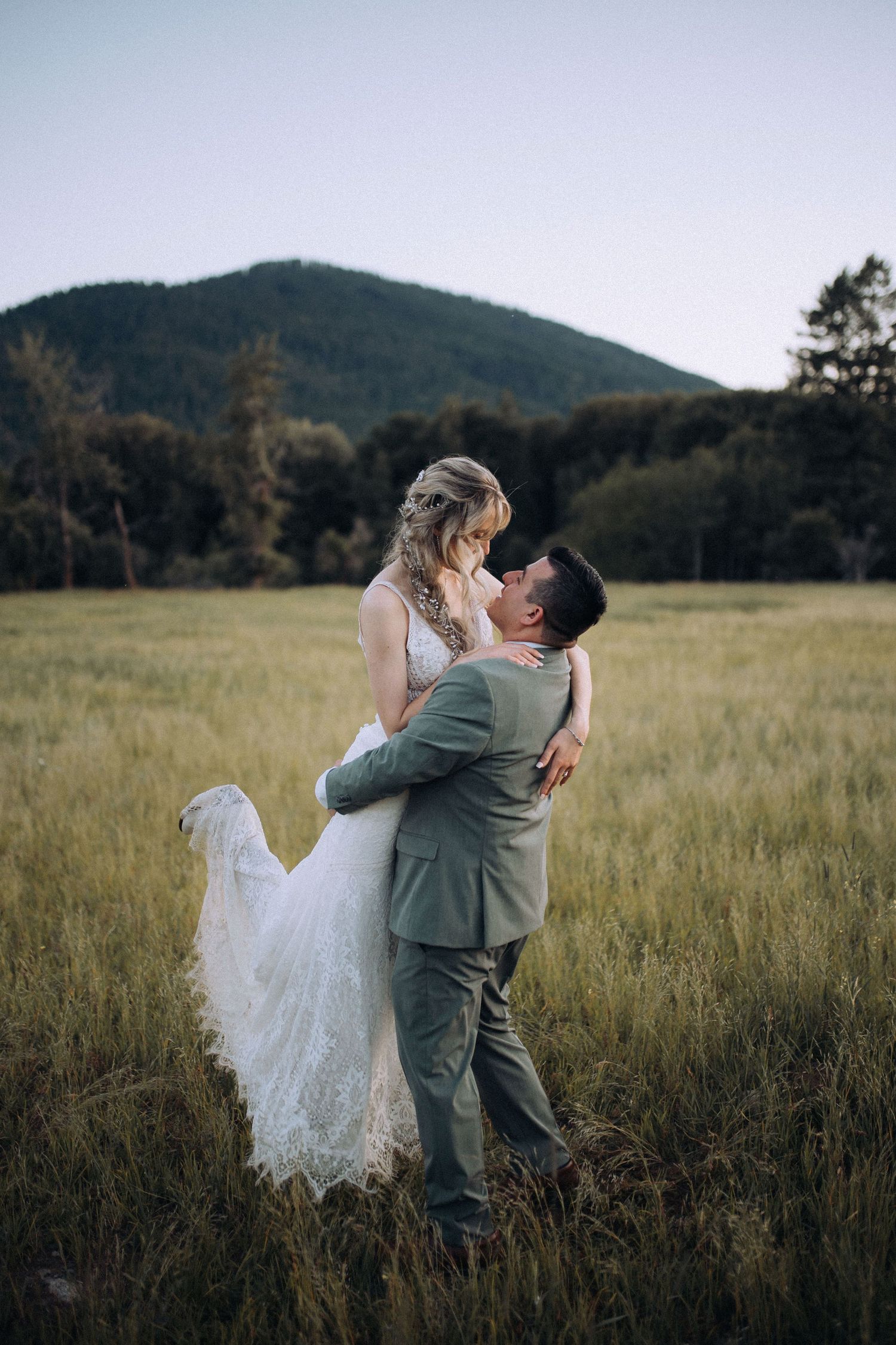Bride and groom celebrating their North Idaho field wedding surrounded by natural scenery