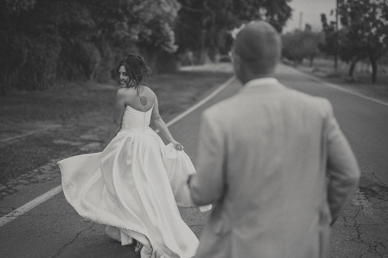 Groom playfully chasing the bride during their Montana wedding portraits